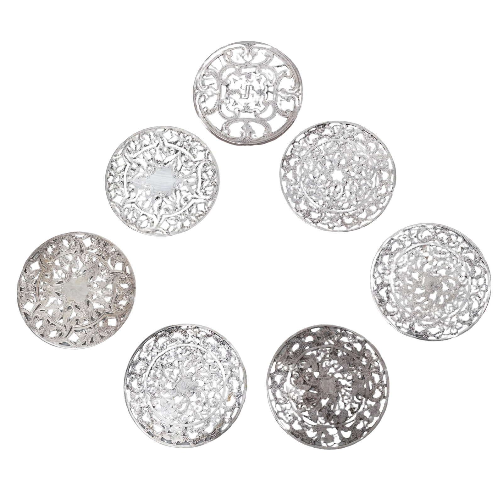 (7pc) Webster Sterling Overlay Glass Coaster: (7pc) Webster Sterling Overlay Glass CoasterEarly to mid 20th Cent., AmericanWebster sterling silver and glass coasters; featuring an ornate Art Nouveau-style pierced floral lace pattern. Stamped with