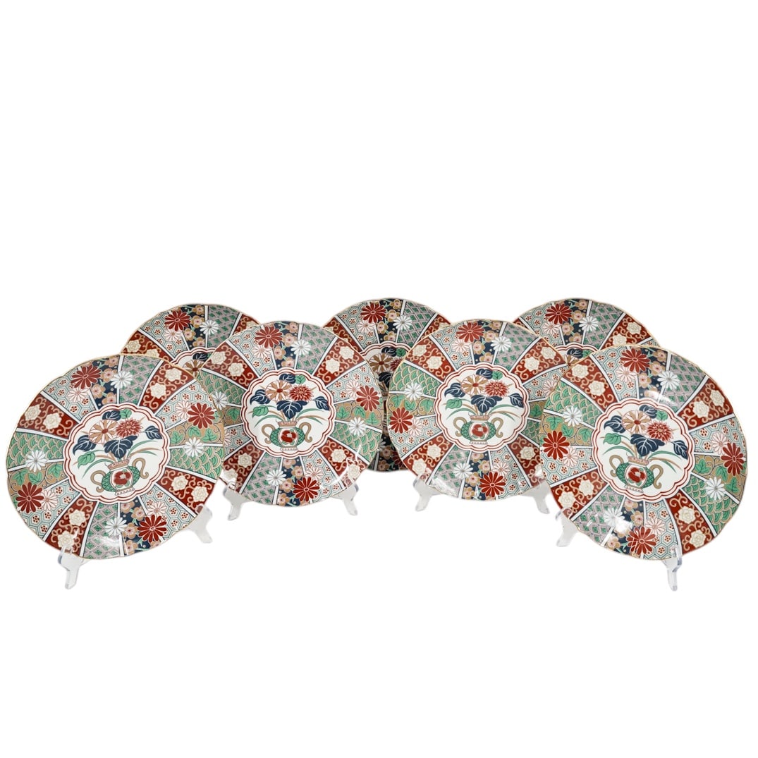 (7 pc) Japanese Arita Imari Fan Porcelain Gold Trim Plates: (7 pc) Japanese Arita Imari Fan Porcelain Gold Trim Plates1980s, JapaneseThe large dinner plates feature a distinctive scalloped edge trimmed in 22K gold. Marked with specific printed stamp found on 1