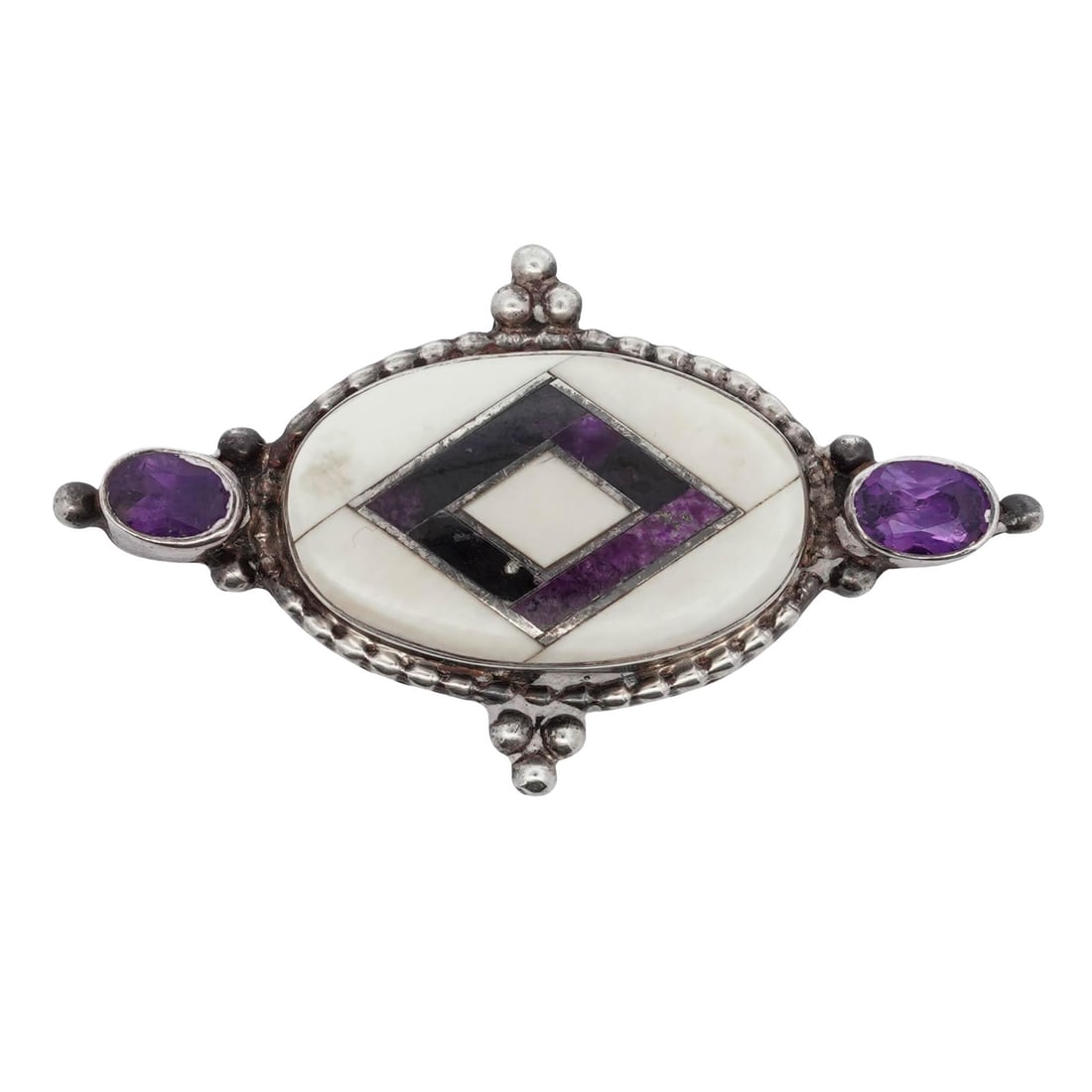 Vintage Silver Amethyst & MOP Inlay Brooch: Vintage Silver Amethyst & MOP Inlay BroochLate 20th CenturyVintage silver brooch of elongated oval form, centered with an inlaid geometric panel composed of mother-of-pearl ground with diamond-shaped