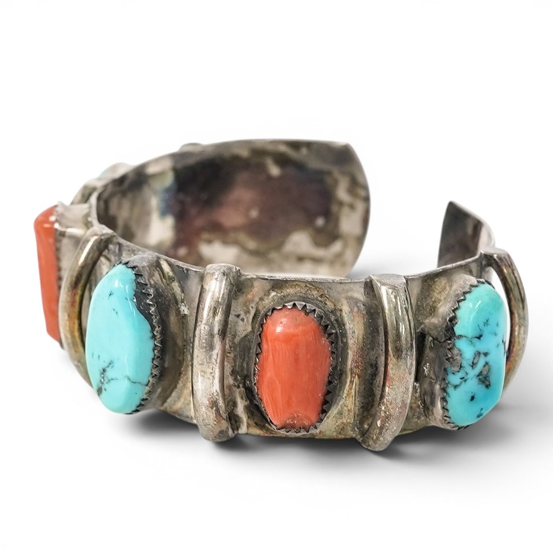 Vintage Navajo Sterling Silver Turquoise & Coral Cuff Bracelet: Vintage Navajo Sterling Silver Turquoise & Coral Cuff Bracelet 1970s–1980s, USA Vintage Navajo cuff bracelet set with turquoise and coral cabochons in sawtooth bezels, accented by raised silver