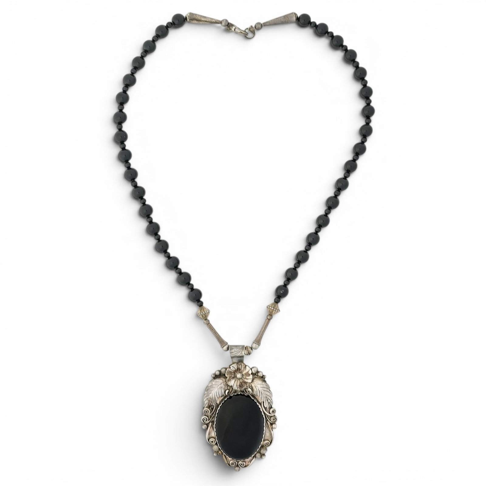 Morty Johnson Navajo Sterling Silver & Onyx Pendant Necklace: Morty Johnson Navajo Sterling Silver & Onyx Pendant Necklace 1980s–1990s, USA Navajo sterling silver pendant necklace by Morty Johnson with large oval onyx cabochon in a sawtooth bezel, accented by