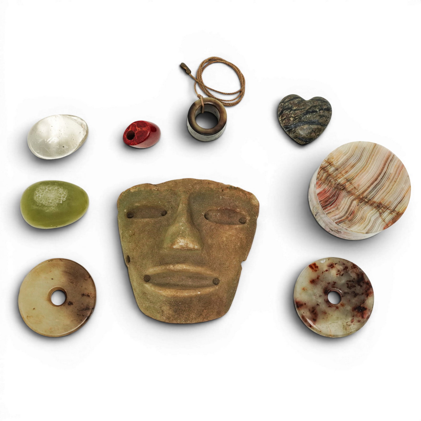 (9pc) Assorted Collection Of Stone Objects: (9pc) Assorted Collection Of Stone Objects 20th Cent. The collection includes several banded onyx objects and a prominent, stylized grey stone mask with carved features typical of decorative art. It