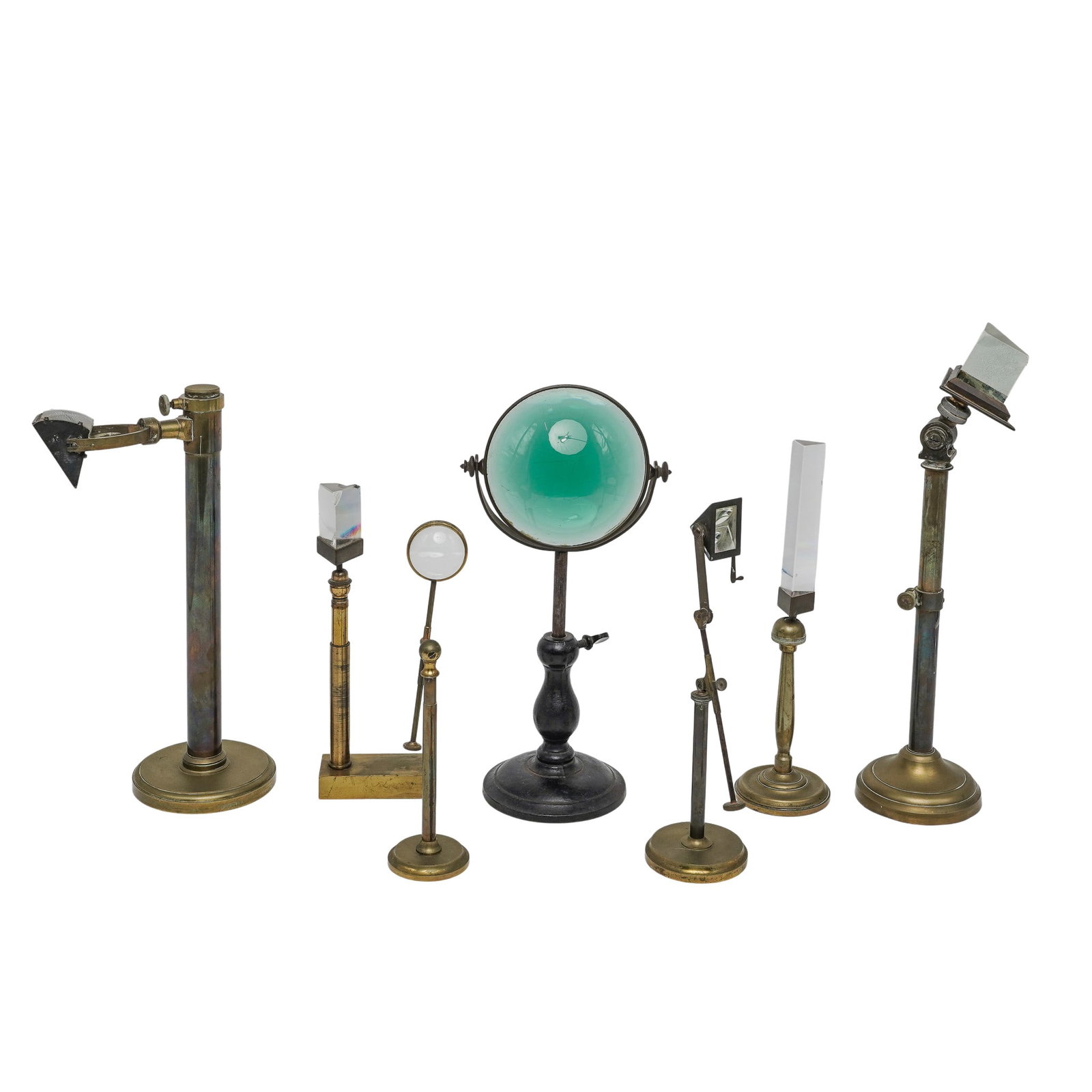 (7pc) Antique Brass Optical Prism Stands & Lens Holders: (7pc) Antique Brass Optical Prism Stands & Lens Holders Late 19th Cent to early 20th Cent The lot contains a series of hand-turned brass and ebonized wood support pillars, each equipped with heavy-wei