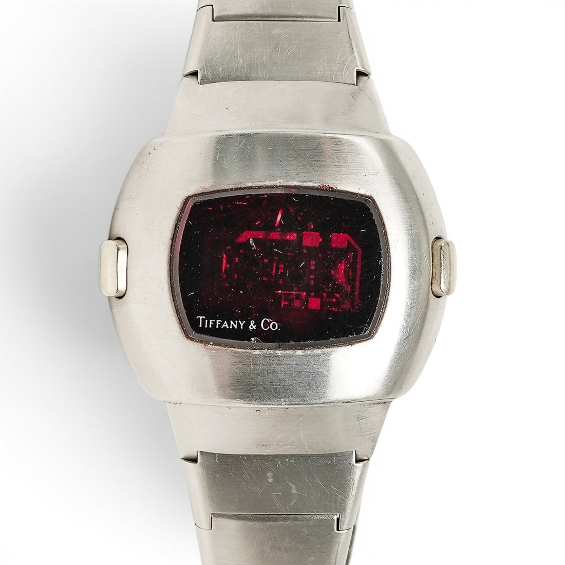 Tiffany & Co. Pulsar Time Computer LED Watch: Tiffany & Co. Pulsar Time Computer LED Watch 1970s, USA Vintage watch featuring a red LED display etched "Tiffany & Co." with a stainless steel case and link bracelet. The back of the case is stamped