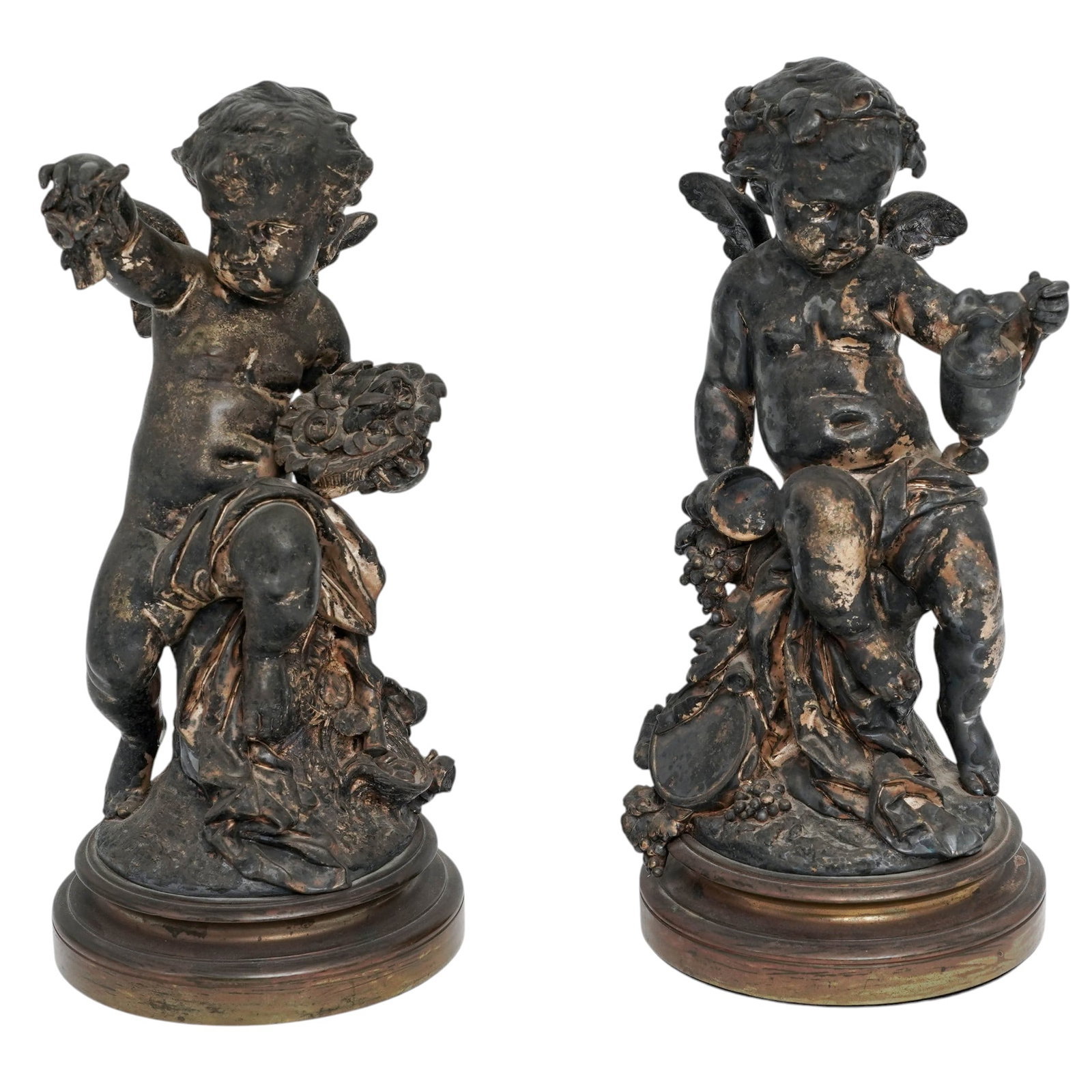 Pair Large 19th Century Cast Bronze Putti Sculptures: Pair Large 19th Century Cast Bronze Putti Sculptures 19th century, European Both bronze putti sculptures feature a dark, patinated finish with significant gold highlights rubbed onto the raised