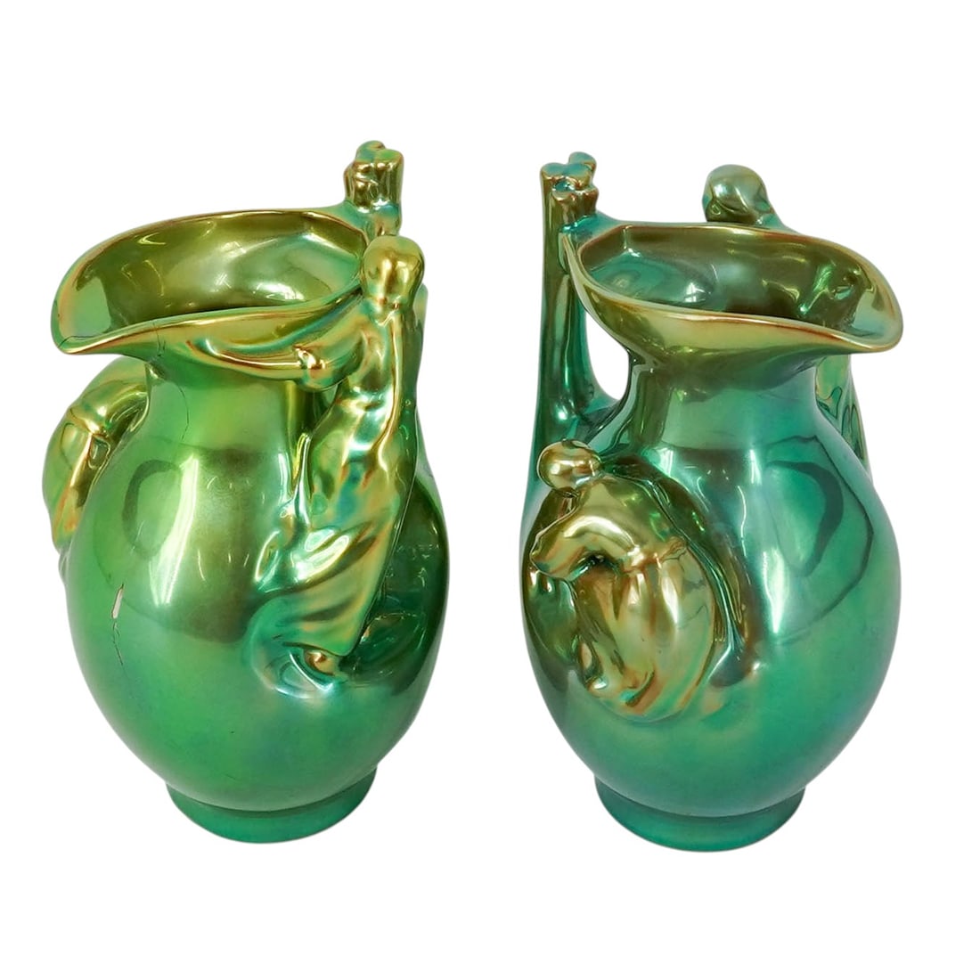 Pair of Zsolnay "Gathering Sticks" Pitchers: Pair of Zsolnay "Gathering Sticks" Pitchers Circa 1900-1910. Hungarian This pair of antique Zsolnay Pécs Art Nouveau pitchers features the rare, high-relief "Gathering Sticks" motif finished in a lum