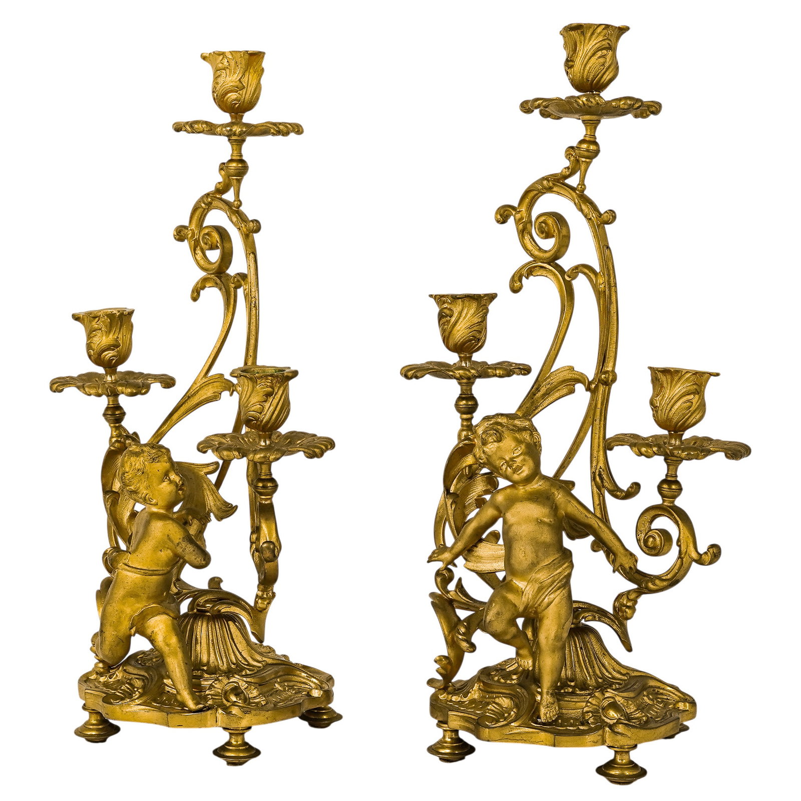 Pair Of French Louis XV Style Ormolu Candelabras: Pair Of French Louis XV Style Ormolu Candelabras 19th Cent., French This pair of French Louis XV-style candelabras exemplifies the Rococo aesthetic, with each featuring a central seated putto atop a h