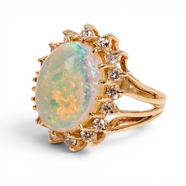 14k Gold Opal & Diamond Cocktail Ring: 14k Gold Opal & Diamond Cocktail Ring 1980s-1990s, USA 14k yellow gold cocktail ring featuring a large oval cabochon opal weighing approximately 7.00 carats, set in a raised basket-style gallery with 
