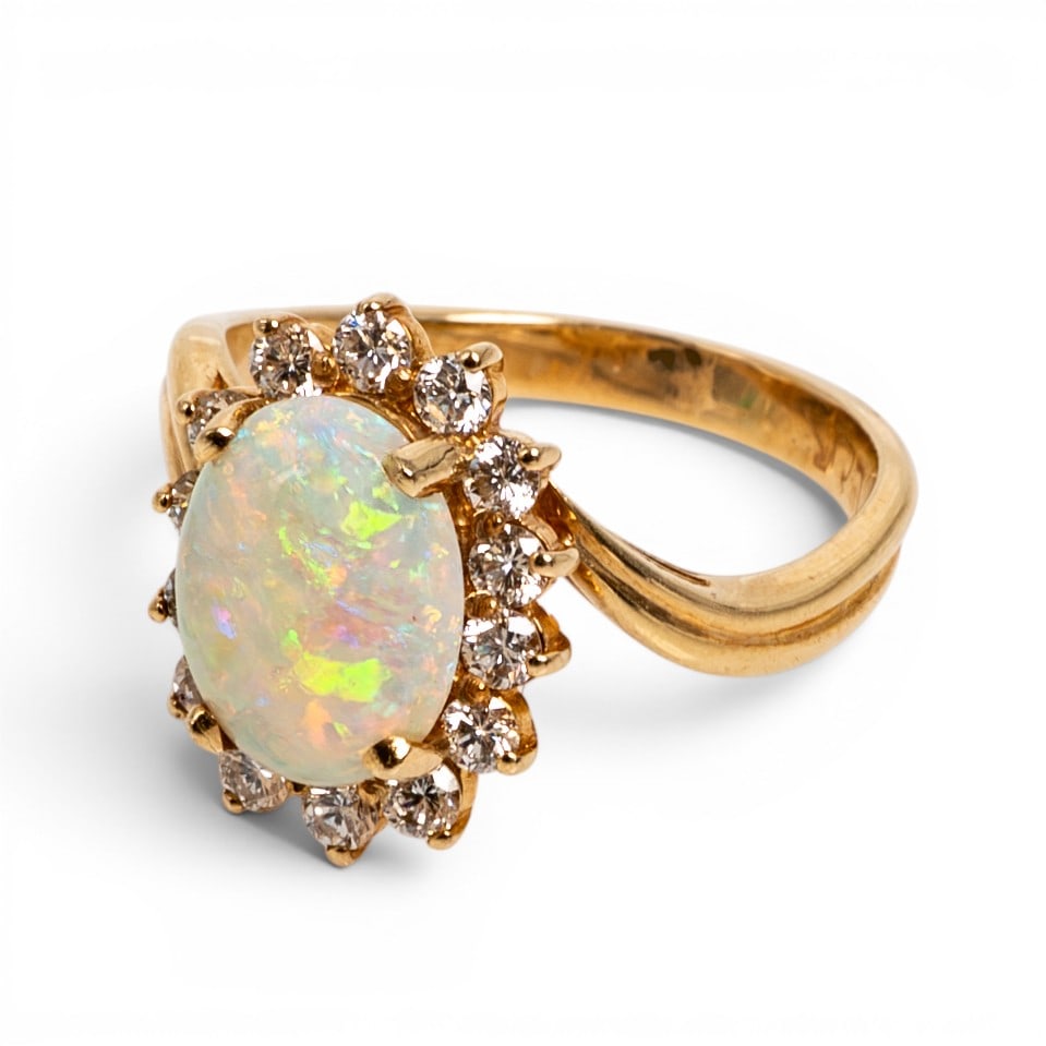 Spark Creations 14k Gold Opal & Diamond Ring: Spark Creations 14k Gold Opal & Diamond Ring 1990s-2000s, USA Spark Creations 14k yellow gold ring featuring an oval cabochon opal weighing approximately 1.75 carats, accented by round diamonds totali