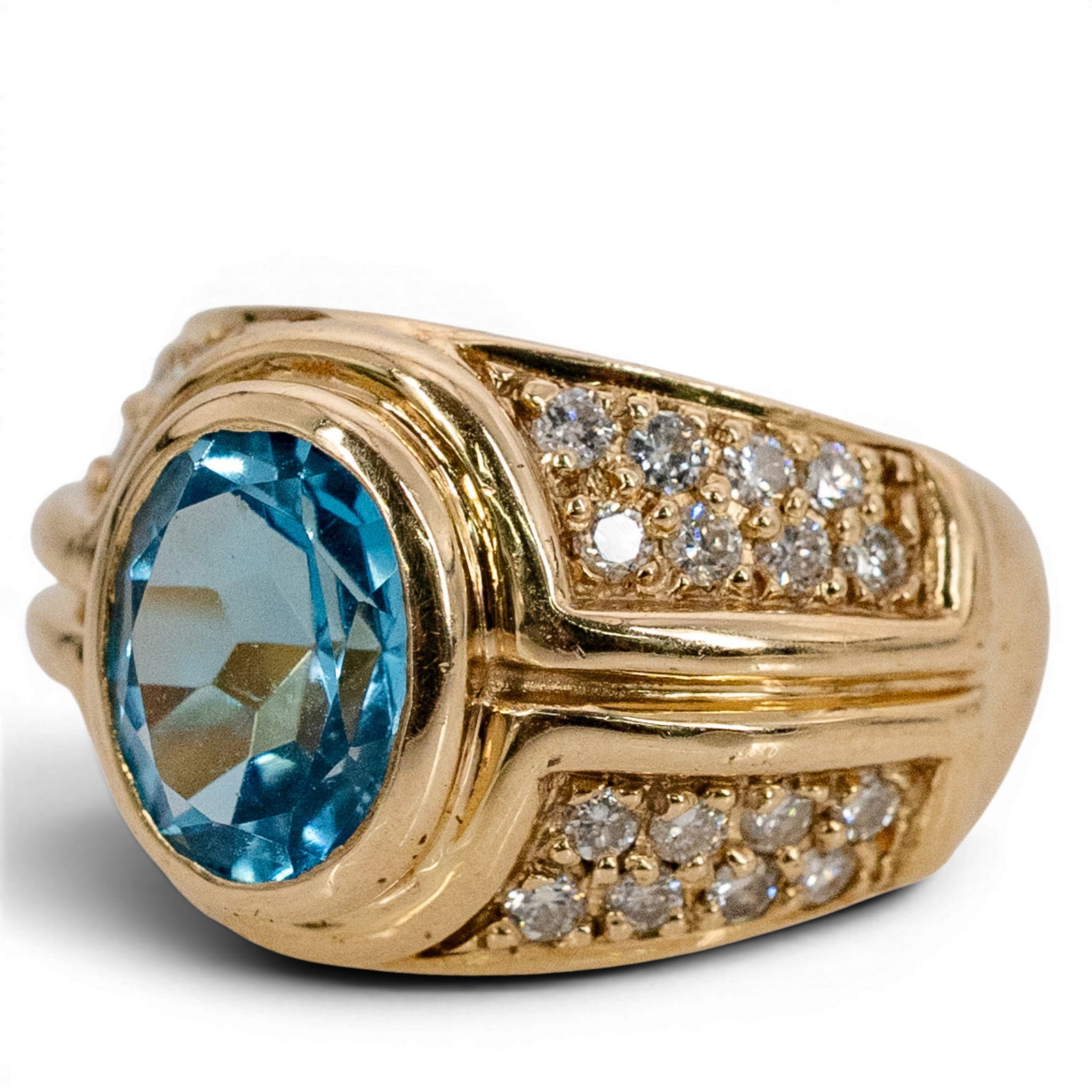 14k Gold Diamond & Blue Topaz Ring Signed: 14k Gold Diamond & Blue Topaz Ring Signed 1990s-2000s 14k yellow gold wide ring featuring an oval faceted blue topaz weighing approximately 3.00 carats, accented by round diamonds totaling approximate