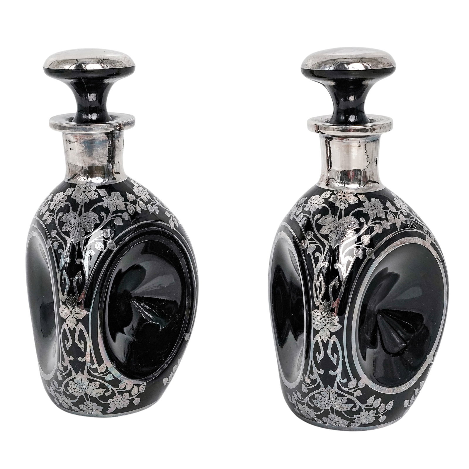 Pair of Antique Sterling Overlay Black Glass Floral Decanters: Pair of Antique Sterling Overlay Black Glass Floral Decanters Early 20th Century, France Pair of black glass decanters with sterling silver overlay decoration, featuring elegant floral and foliate mot