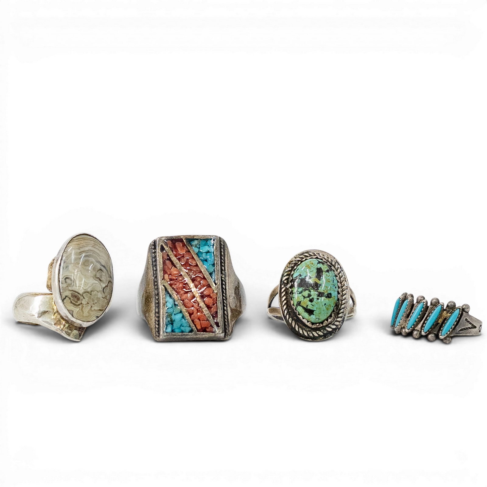 (4 Pcs) Navajo Sterling Silver & Multi-Stone Ring Lot, Signed: (4 Pcs) Navajo Sterling Silver & Multi-Stone Ring Lot, Signed 1970s-1980s, USA Navajo sterling silver ring lot with four rings set with turquoise, coral, and banded agate. Includes one oval turquoise 