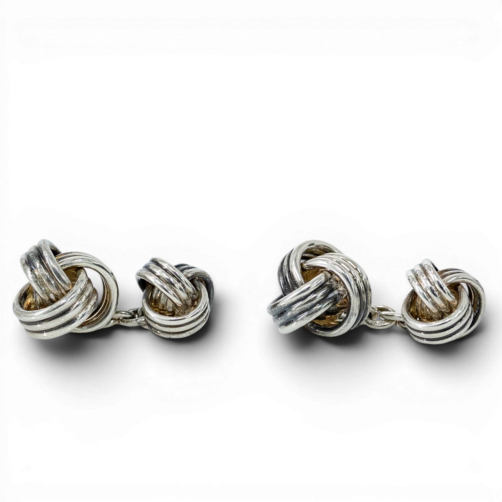 Pair of English Sterling Silver Double Knot Cufflinks: Pair of English Sterling Silver Double Knot Cufflinks Early 20th Cent. English This pair of antique English double knot cufflinks is meticulously crafted in solid sterling silver, featuring a traditio
