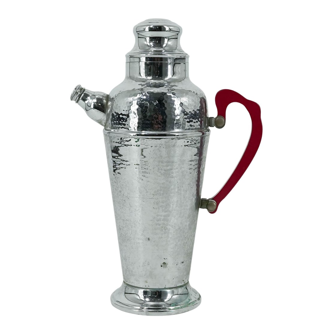 Hammered Chrome and Bakelite Shaker Pitcher: Hammered Chrome and Bakelite Shaker Pitcher 20th century A hammered stainless chrome cocktail shaker with red bakelite handle. Marked "stainless chrome" on bottom. H 13" x L (spout to handle) 8" x