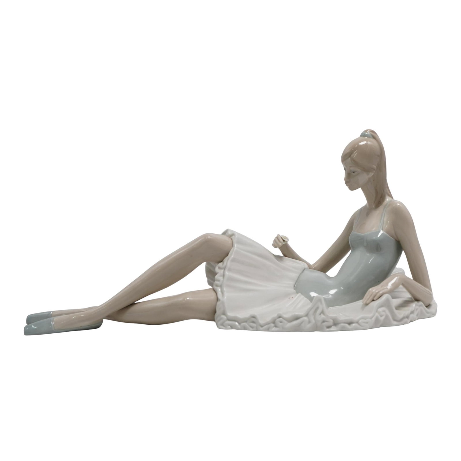 Lladro "Reclining Ballerina" Glazed Porcelain Figurine: Lladro "Reclining Ballerina" Glazed Porcelain Figurine 20th Century, Spain Large Lladro glazed porcelain figurine depicting a "Reclining Ballerina" holding a flower on her right hand. Marked with Llad