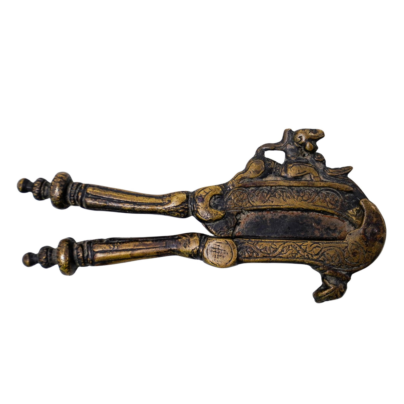Southeast Asian Brass Betel Nut Cutter: Southeast Asian Brass Betel Nut Cutter 20th century, Asia The betel nut cutter is made of gilded brass and has animal figure on the top. It has an engraved pattern. L: 6" W: 2 3/4"