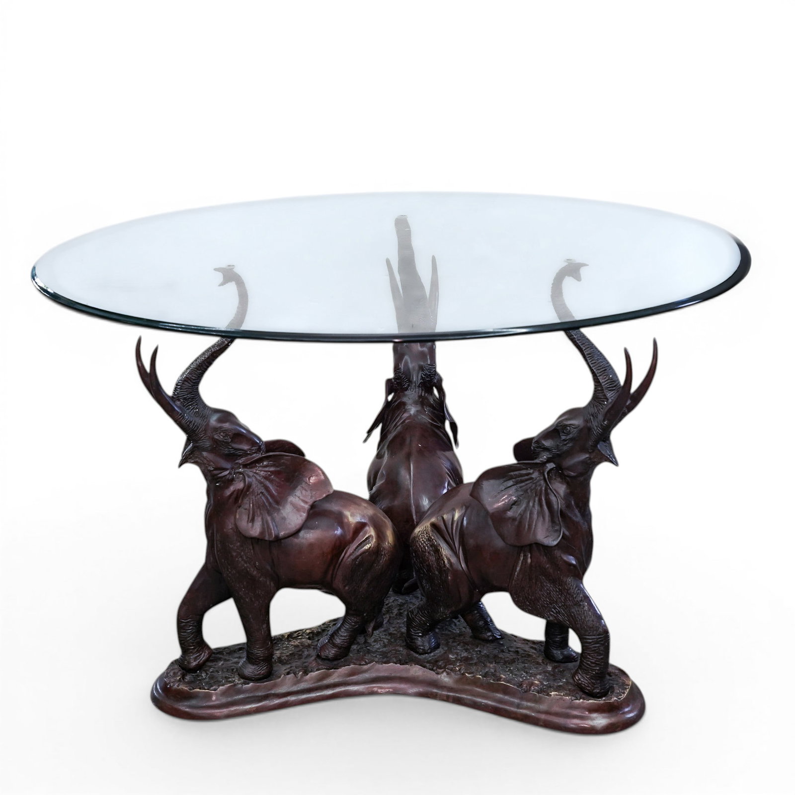 Hollywood Regency Bronze Elephant Table: Hollywood Regency Bronze Elephant Table Mid 20th century Hollywood Regency round coffee table featuring three patinated bronze sculptures of elephants with raised trunks supporting a round beveled gla