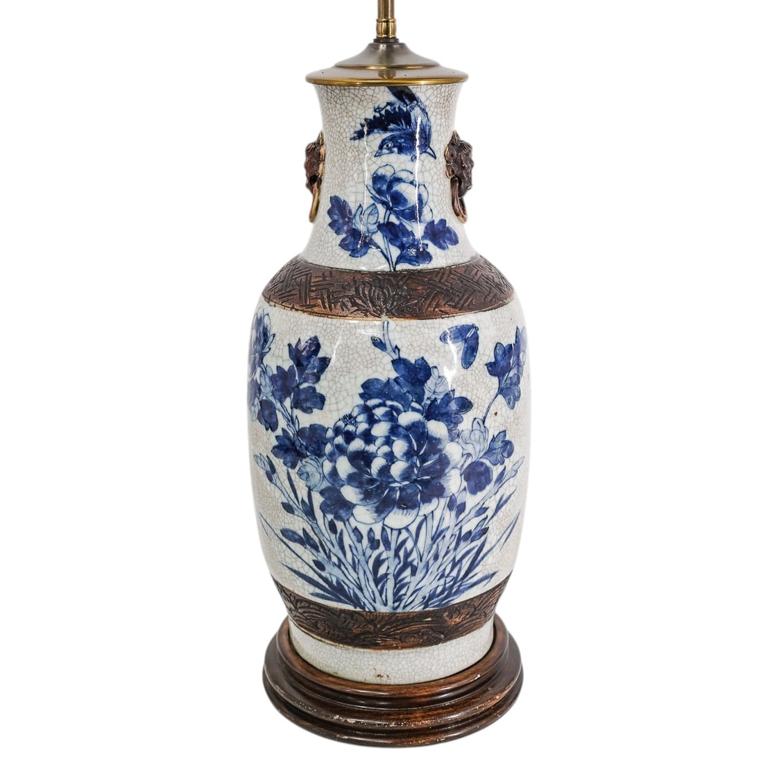 Antique Chinese Blue and White Porcelain Table Lamp: Antique Chinese Blue and White Porcelain Table Lamp Early 20th century, Chinese A Chinese blue and white crackle glaze porcelain table lamp with large floral motifs and converted into a lamp. Raised l