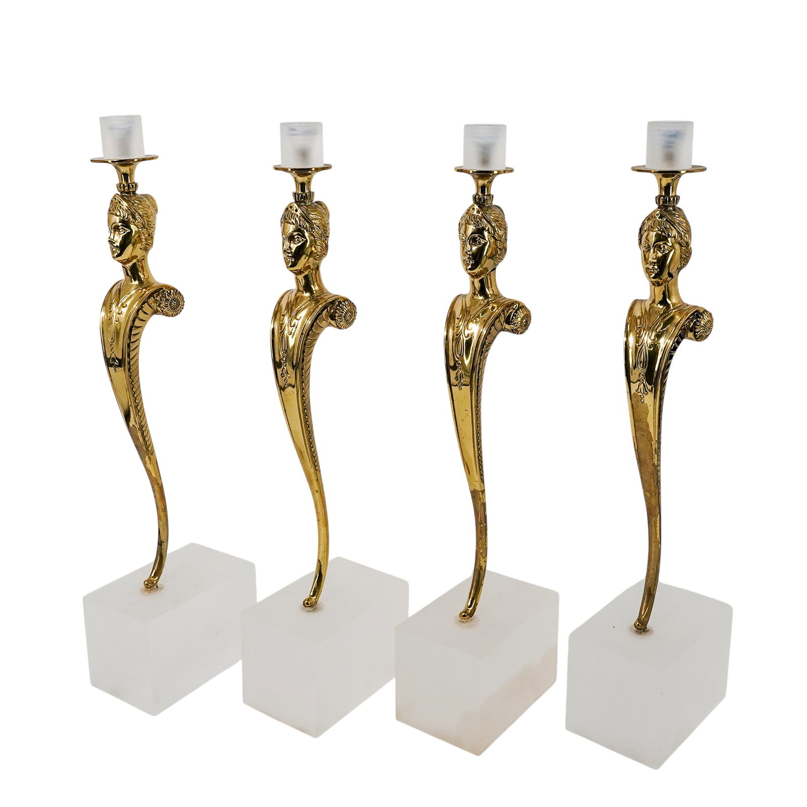 (4pc) Hollywood Regency Brass Caryatid Candleholders: (4pc) Hollywood Regency Brass Caryatid Candleholders 20th Cent. This is a group of four Hollywood Regency candleholders, each designed as a stylized Empire-style caryatid. The pieces are cast in bronz
