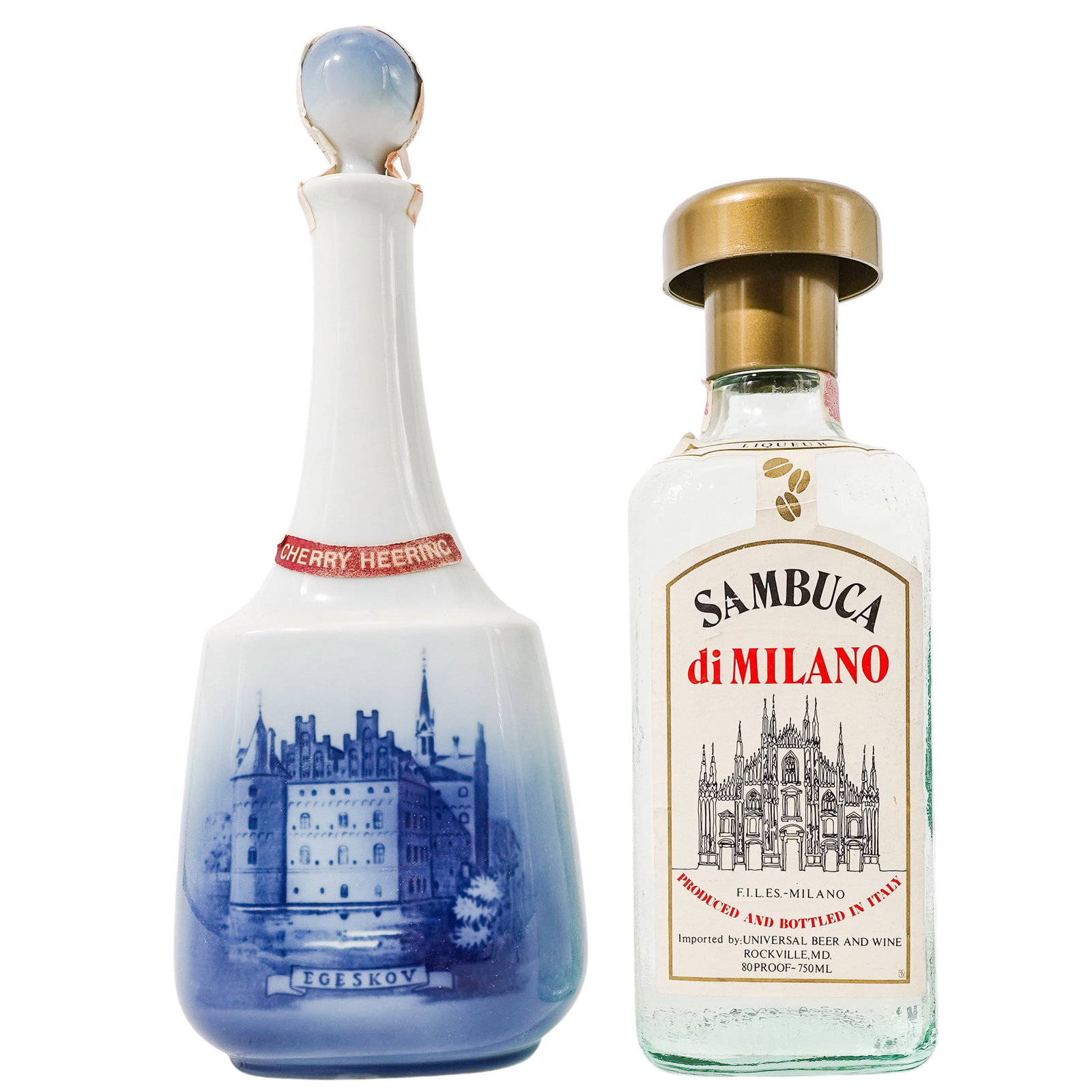 (2 Pc) Vintage Sambuca & Cherry Heering Liqueur Bottles: (2 Pc) Vintage Sambuca & Cherry Heering Liqueur Bottles Late 20th c., Denmark & Italy Cherry Heering liqueur in a porcelain decanter produced by Royal Copenhagen depicting a scene of Egeskov Castle in