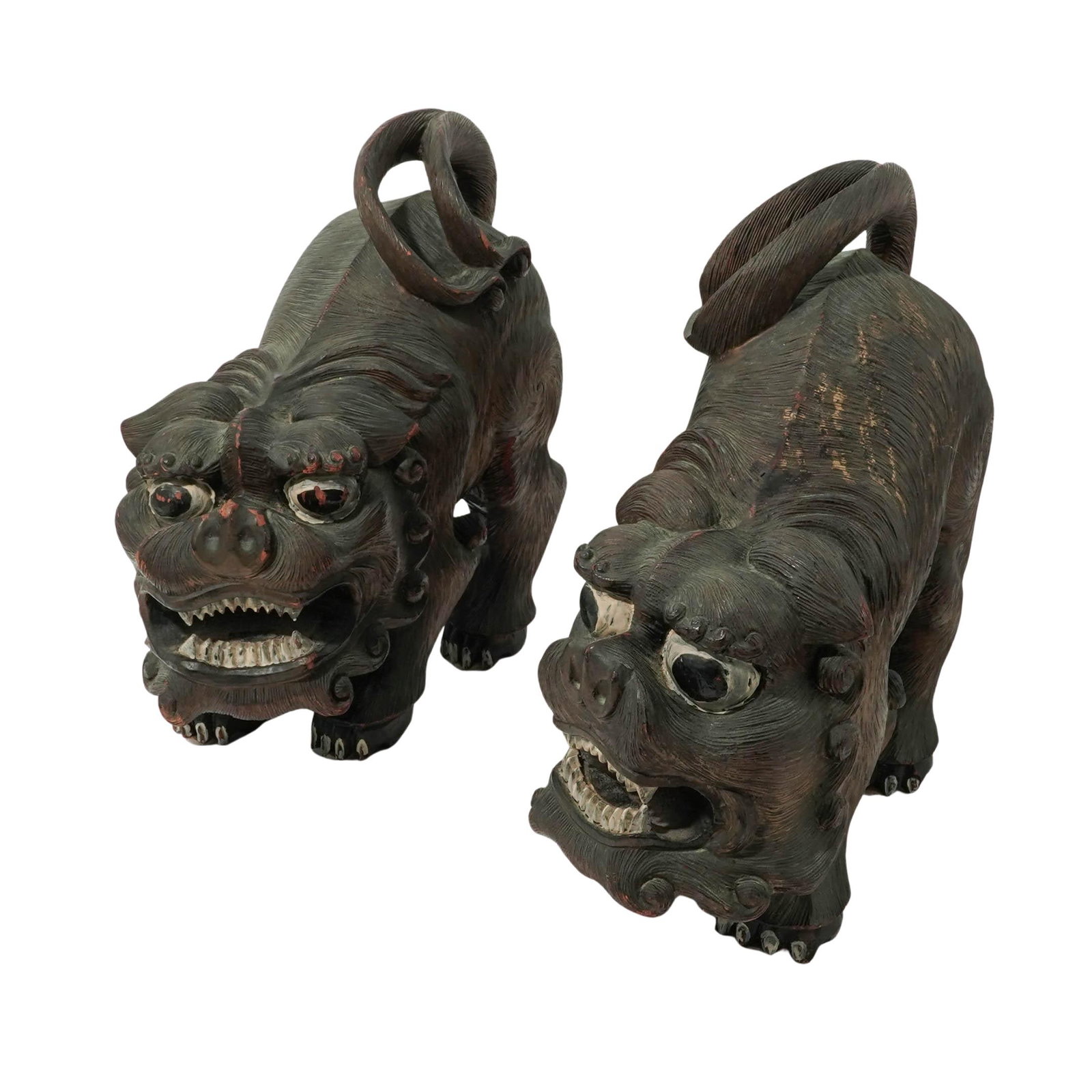 Vintage Pair of Chinese Carved Wood Foo Dogs: Vintage Pair of Chinese Carved Wood Foo Dogs Mid-20th Century, China. Pair of Chinese Carved Wood Guardian Lion (Foo Dog) Figures, each modeled with stylized features, bulging eyes, and textured manes