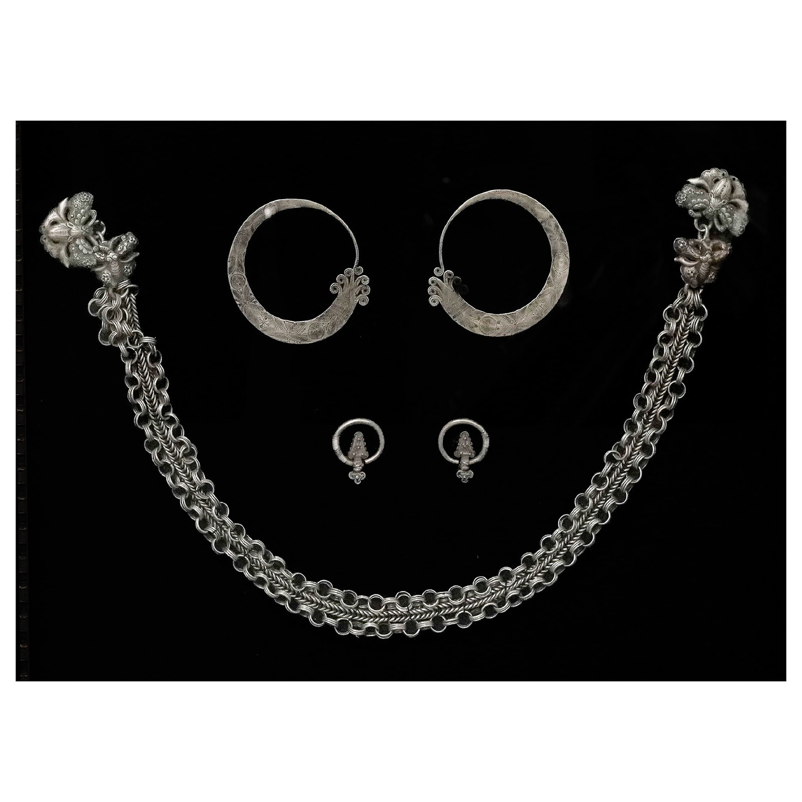 Antique Hmong & Yao Silver Earrings & Necklace: Antique Hmong & Yao Silver Earrings & Necklace Late 19th Century, Vietnam. Including a pair of large hoop earrings, a chain-form necklace with ornate terminals, and a pair of smaller earrings, each ex
