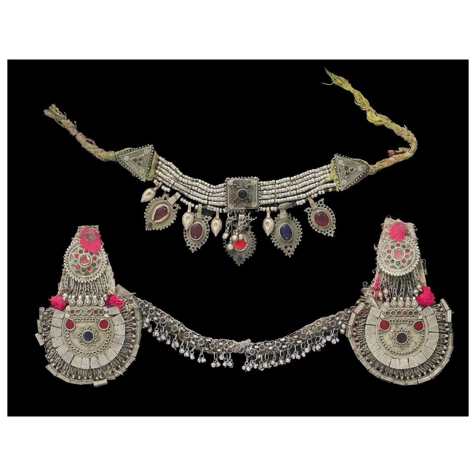 Pair of Vintage Afghan Silver Plated Necklaces: Pair of Vintage Afghan Silver Plated Necklaces Mid-20th Century, Afghanistan Including two traditional Afghan necklaces featuring white metal construction with suspended medallions, beadwork, colored 