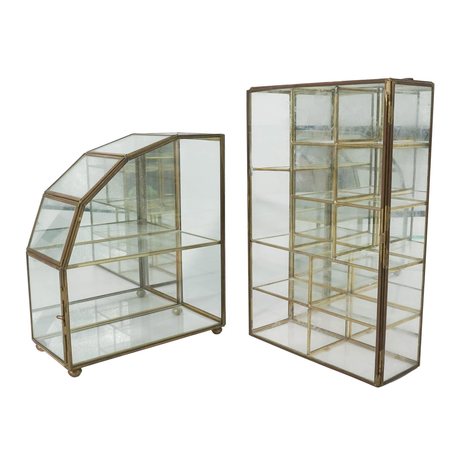 (2 Pc) Vintage Brass & Glass Curio Cabinets: (2 Pc) Vintage Brass & Glass Curio Cabinets Mid-20th Century, USA Group of two vintage brass and glass curio cabinets, each of rectilinear form with clear glass panels and gilt-tone metal framework. O