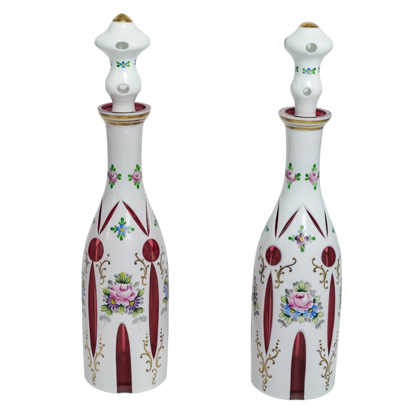 Pair of Antique Bohemian Cut Glass Decanters: Pair of Antique Bohemian Cut Glass Decanters Mid-20th Century, Czechia. Matched pair of Bohemian glass decanters, each of faceted form with elongated neck and fitted stopper. Decorated with cut and fl