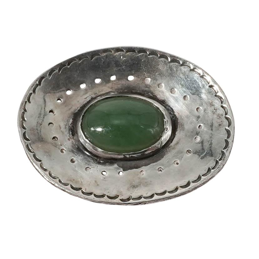 Vintage Bruce Wood Sterling & Green Jade Brooch: Vintage Bruce Wood Sterling & Green Jade Brooch 20th Century, USA. Sterling Silver and Green Jade Brooch by Bruce Wood, of oval form set with a polished green jade cabochon within a hammered and pierc