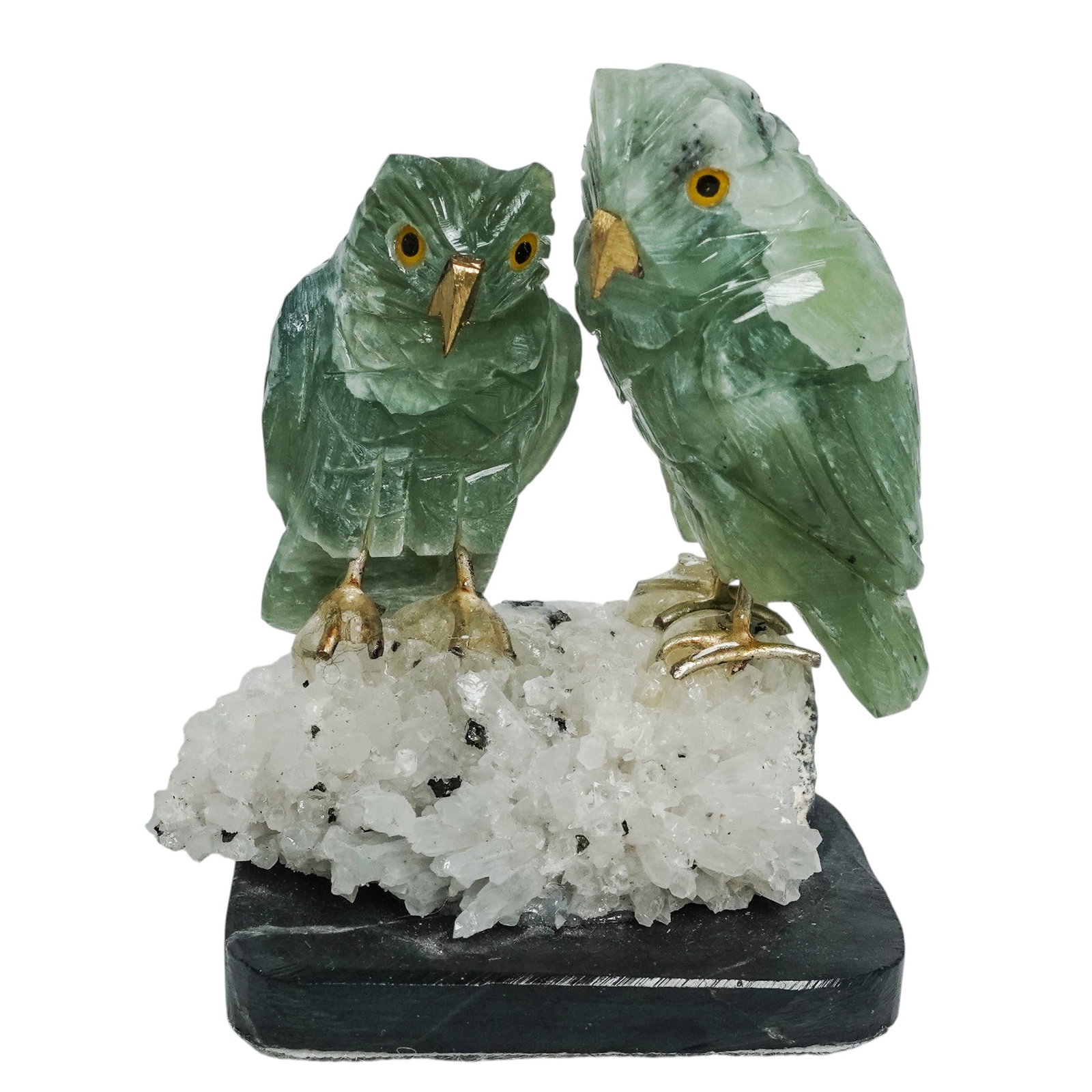 Fluorite & Quartz Carved Owls: Fluorite & Quartz Carved Owls Late 20th Century, USA. Carved hardstone figure depicting two owls, rendered in green fluorite with inset eyes and perched on a natural quartz crystal base, mounted on a 