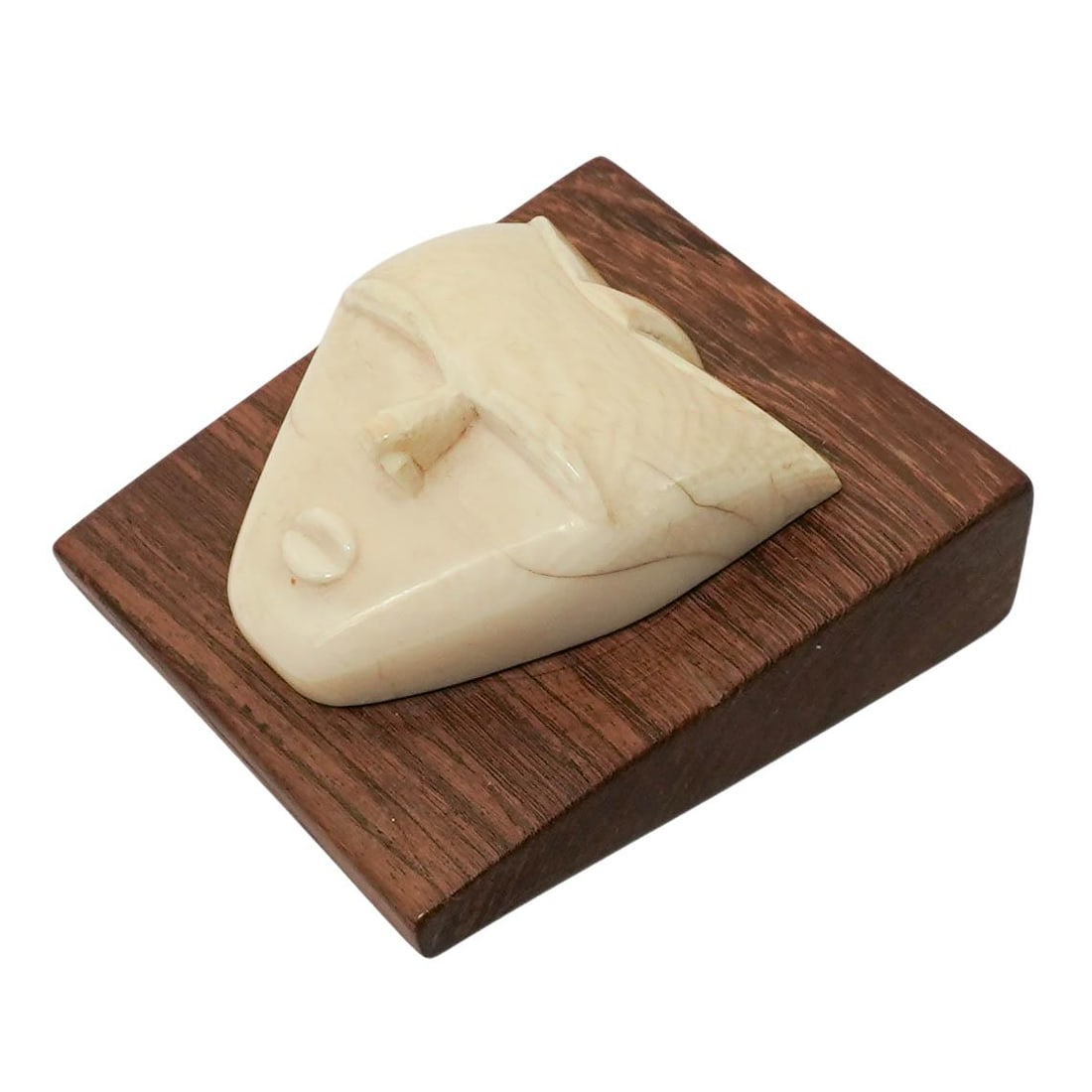 Vintage Hand Carved Bone Face Mask: Vintage Hand Carved Bone Face Mask Mid 20th Cent. Mounted on a polished hardwood plaque, the piece is masterfully carved from dense animal bone to depict a minimalist "Spirit Face". L: 3 1/8" W: 2 7/8