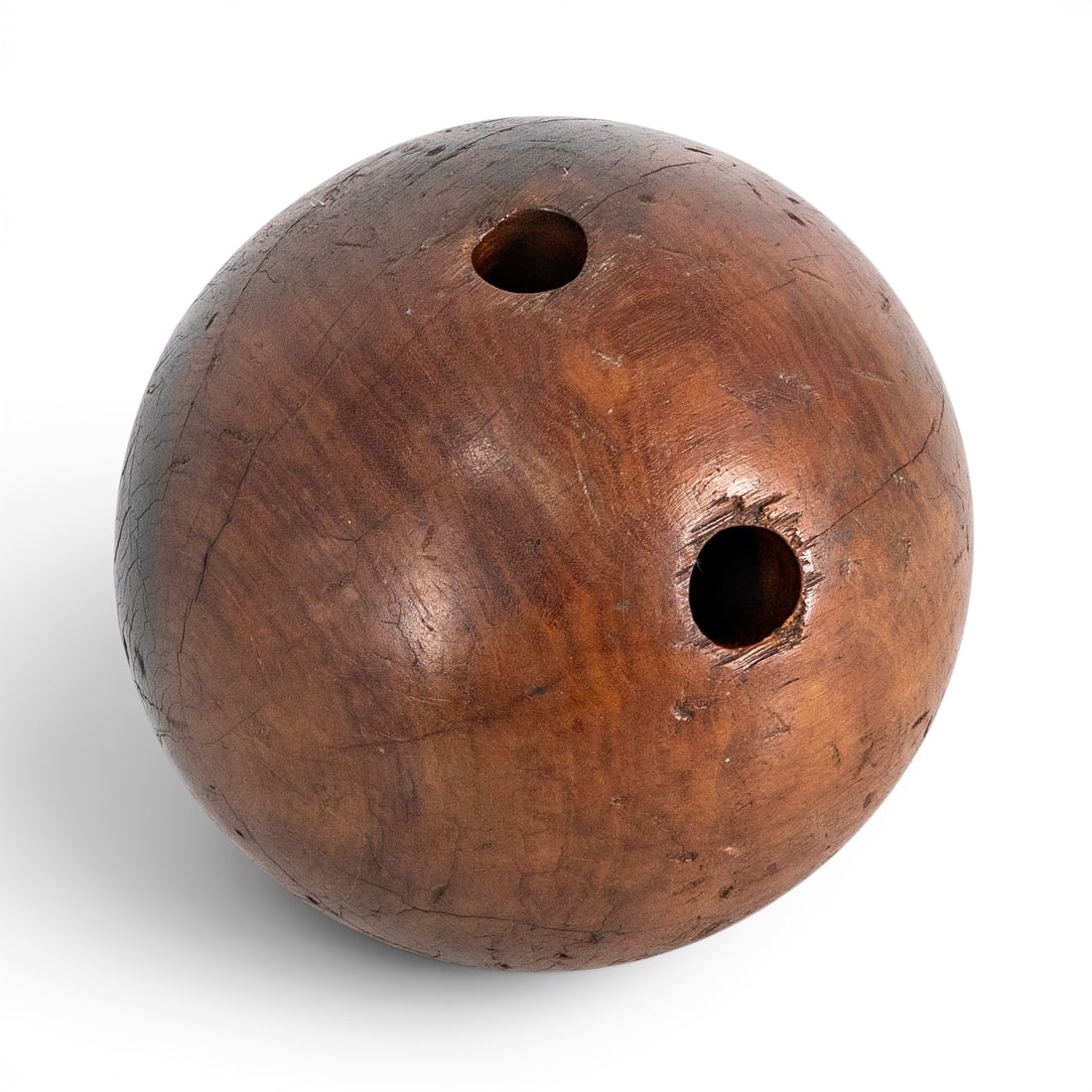 Antique Wooden Bowling Ball: Antique Wooden Bowling Ball 20th Century, USA. Turned hardwood bowling ball of classic spherical form with finger holes. Exhibits natural wood grain throughout, characteristic of pre-resin bowling equ