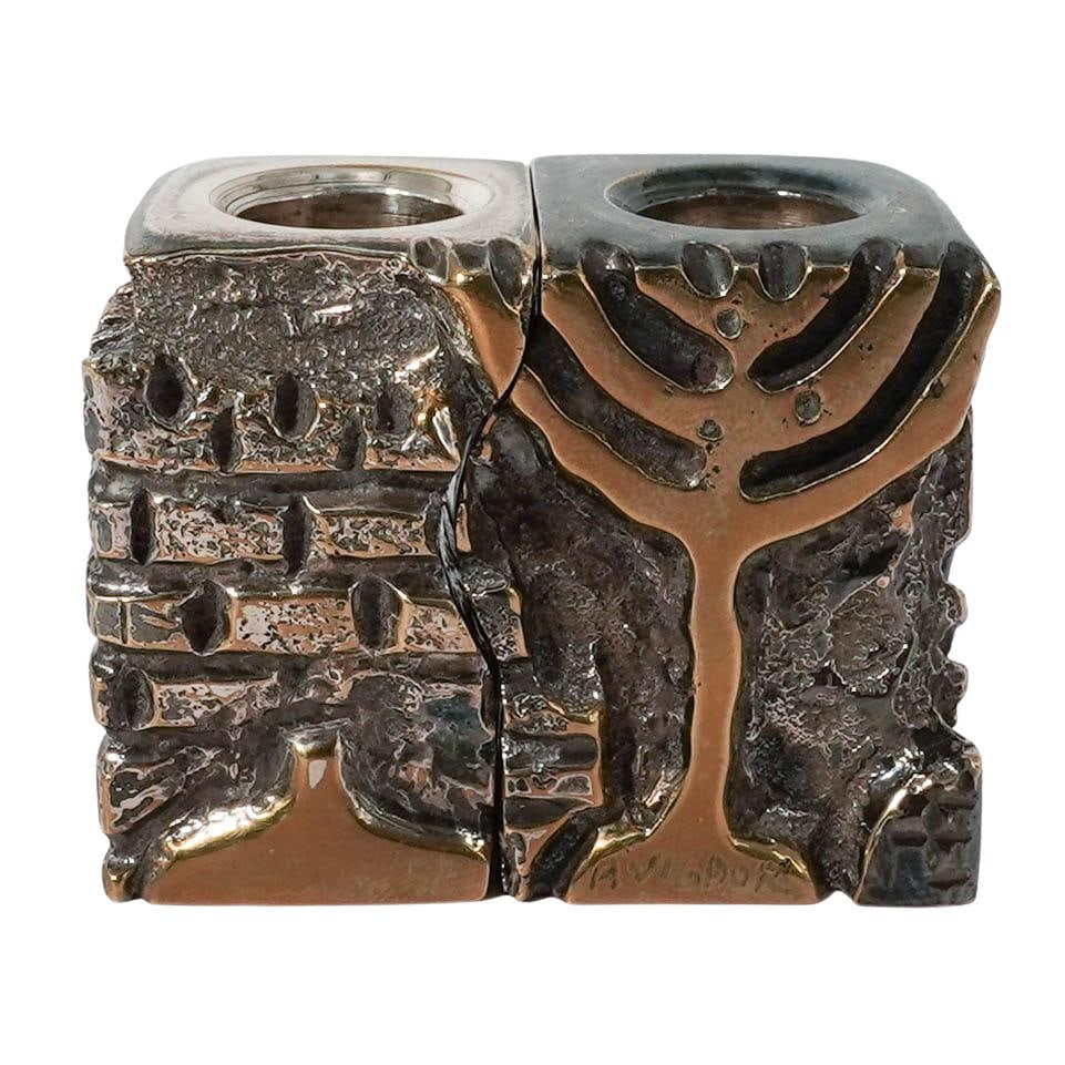 Pair of 'Avigdor' Judaica Brass Candlestick Holders: Pair of 'Avigdor' Judaica Brass Candlestick Holders 1983, Israel Detailed cast brass candleholders that fit perfectly together or can stand apart. Artist engraved signature on the base of one stand, a