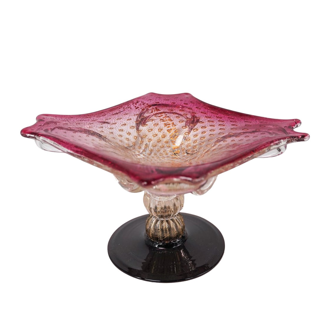 Murano Glass Gold Flecked Pedestaled Dish: Murano Glass Gold Flecked Pedestaled Dish20th c., ItalyMurano cranberry and clear glass dish with gold flecks and a round purple base. It has a "Genuine Venetian Glass Made in Murano, Italy" sticker o
