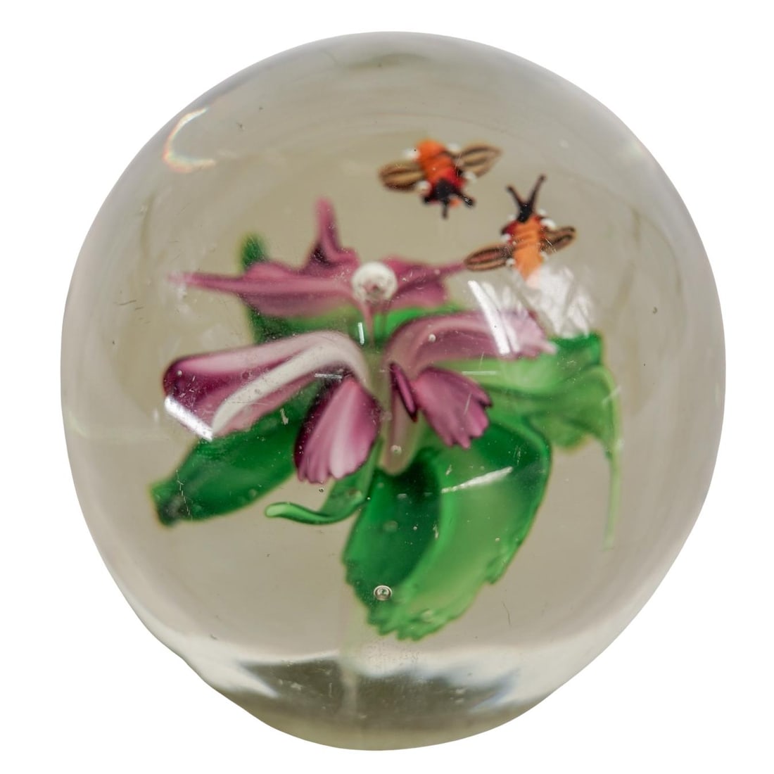 Lampwork Flower and Bee Glass Paperweight: Lampwork Flower and Bee Glass PaperweightMid to late 20th Cent., ChinaVintage lampwork glass paperweight featuring a pink flower with green leaves and a small bee hovering above, all encased in clear