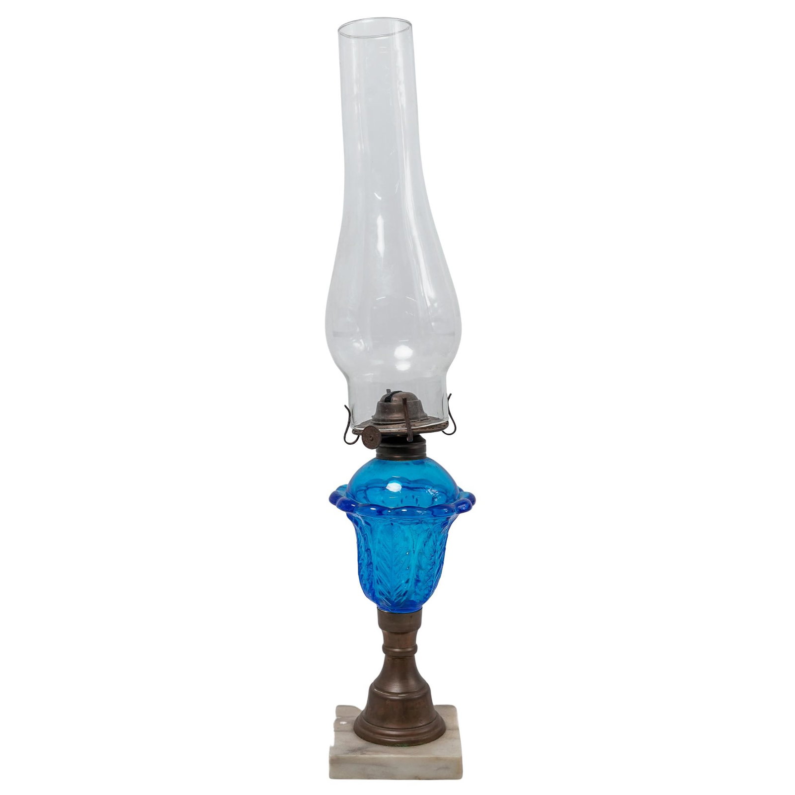 Vintage Cobalt Blue Glass Oil Lamp: Vintage Cobalt Blue Glass Oil Lamp Mid 20th Cent. USA Vintage oil lamp in the Victorian style, featuring a pressed cobalt blue glass font with scalloped edges and molded leaf motifs. The lamp is fitte