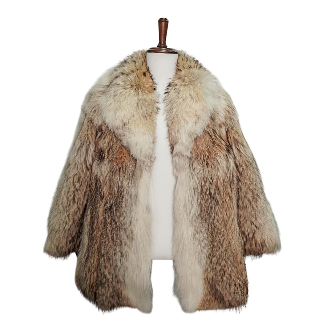Vintage Coyote Fur Coat: Vintage Coyote Fur Coat Mid 20th Cent. USA The coat features a light beige base and brown streaks throughout. It has a generous cut, a plush shawl collar, and long sleeves. The interior lining is