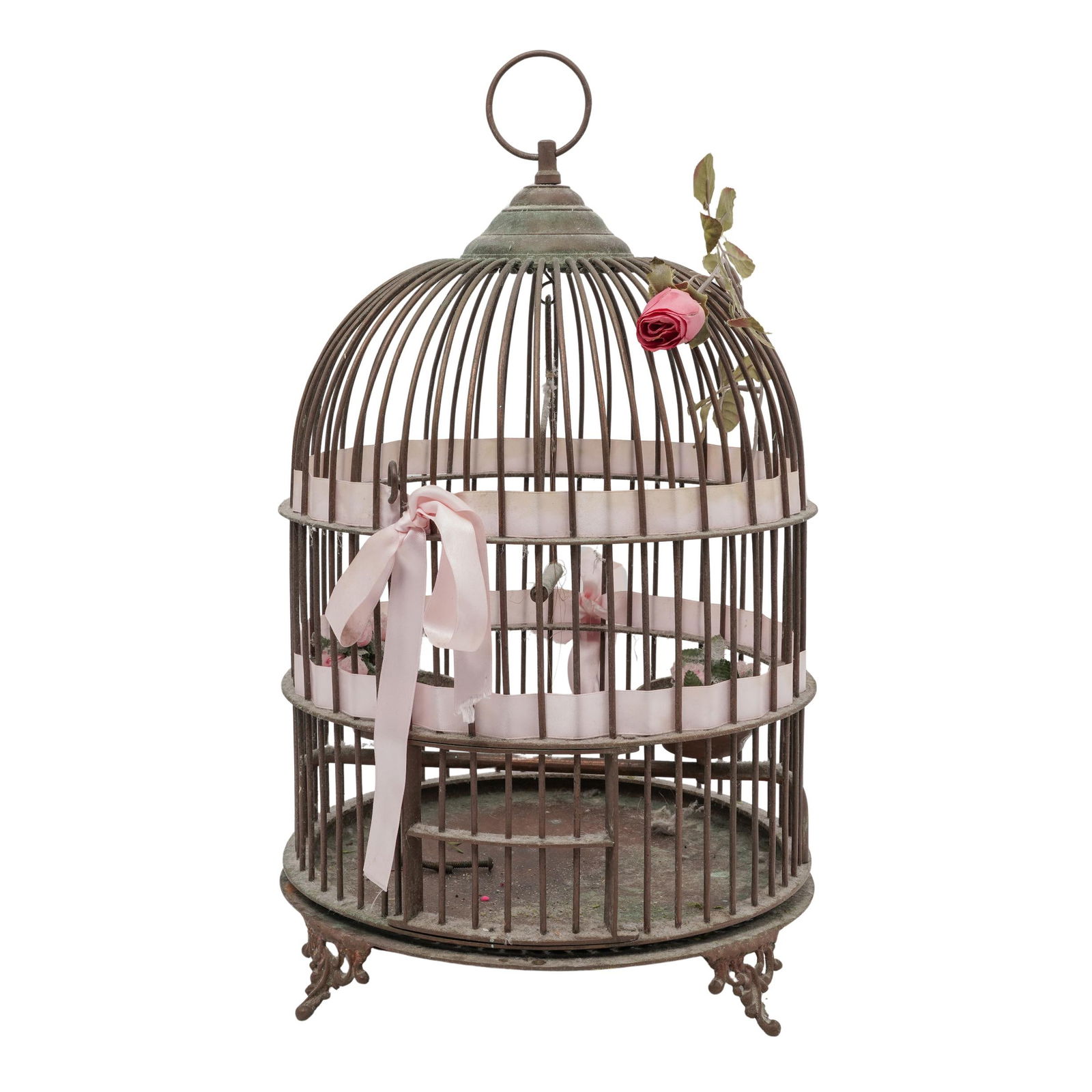 Antique Copper Birdcage: Antique Copper BirdcageEarly 20th centuryAn antique copper and brass birdcage with pink ribbon and rose accents. Floral feet. Two feeders and a bird perch inside. Base unscrews from cage.H 19" Diamete