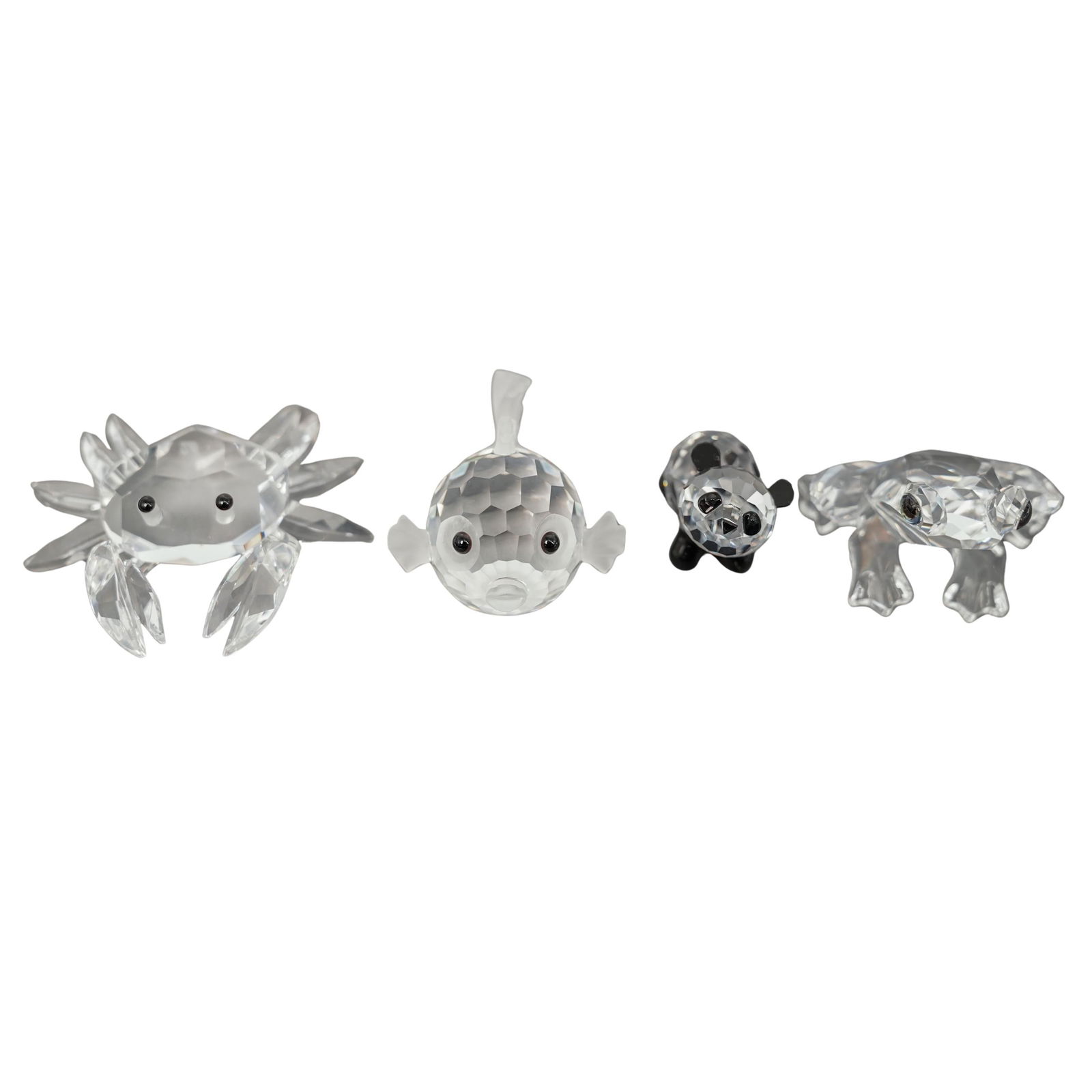 (4 pcs) Swarovski Miniature Animals: (4 pcs) Swarovski Miniature Animals20th century, AustriaA set of four miniature Swarovski crystal animals. Includes a pufferfish, panda, crab, and frog. Each marked with Swarovski swan hallmark.Smalle