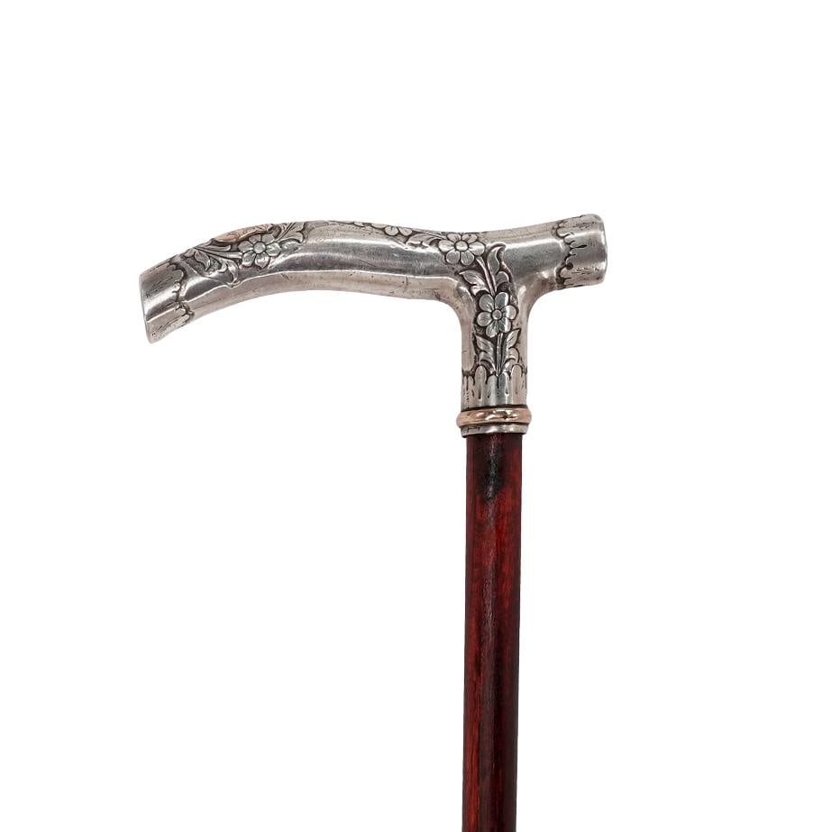 Antique Silver & Gold Handled Wood Cane: Antique Silver & Gold Handled Wood CaneEarly 20th cent. EuropeanSmooth wood cane with a silver handle featuring a floral motif, a rose gold ring at the bottom, and a monogrammed rose gold shield on to