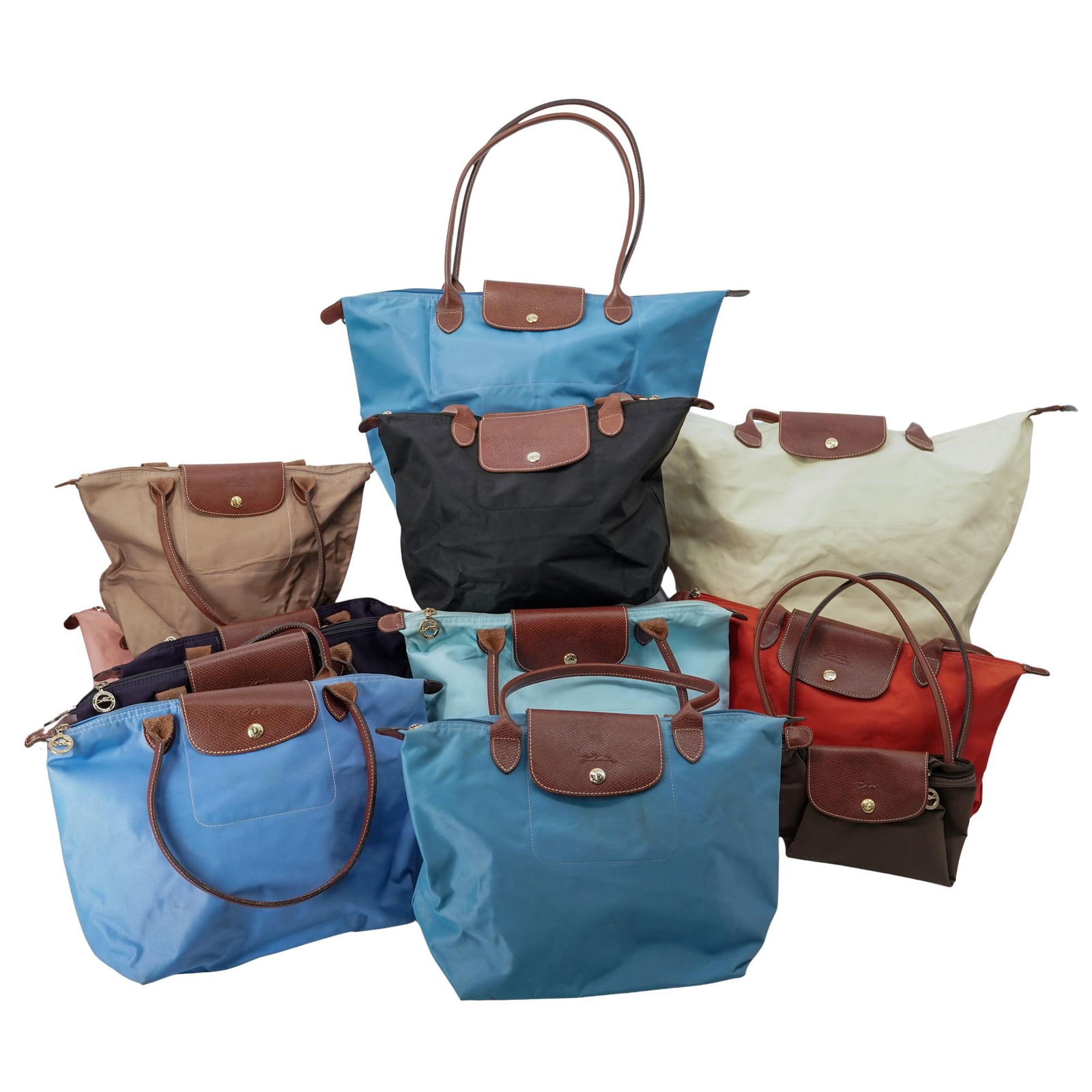 (12 pcs) Longchamp Le Pliage Nylon & Leather Tote Bags: (12 pcs) Longchamp Le Pliage Nylon & Leather Tote Bags21st century, FrenchA set of twelve Longchamp nylon and leather trimmed tote bags in a variety of colors and sizes. All feature gilt hardware to f