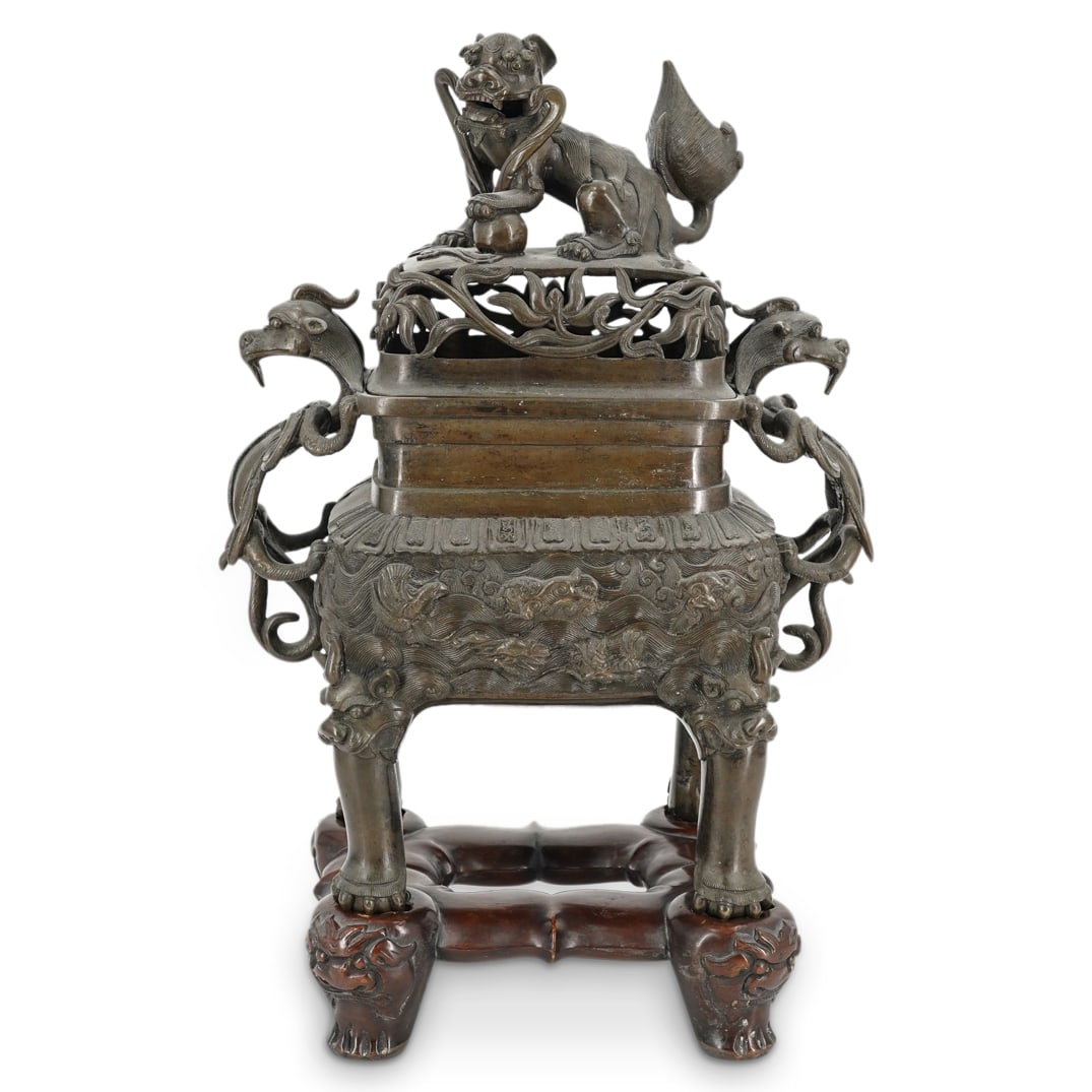 17th-18th C. Chinese Bronze Lidded Censer W/ Wooden Base, Ex-Freeman's: 17th-18th C. Chinese Bronze Lidded Censer W/ Wooden Base, Ex-Freeman's17th to 18th Century, ChinaBronze, lidded censer featuring winged dragon handles on either side and a lid with open-work foliage d