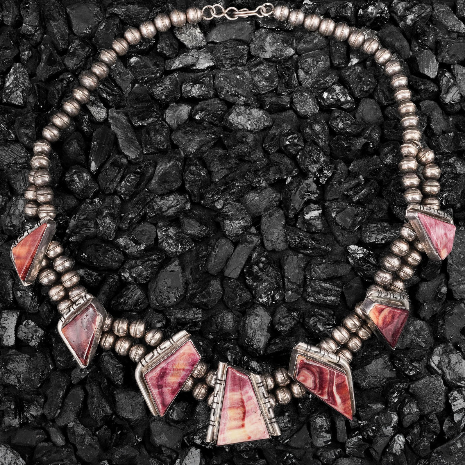 Vintage Navajo Sterling Silver & Spiny Oyster Necklace: Vintage Navajo Sterling Silver & Spiny Oyster NecklaceCirca 1970s-1980s, USAVintage Navajo sterling silver bead necklace with multiple spiny oyster shell inlays in irregular trapezoidal stations along