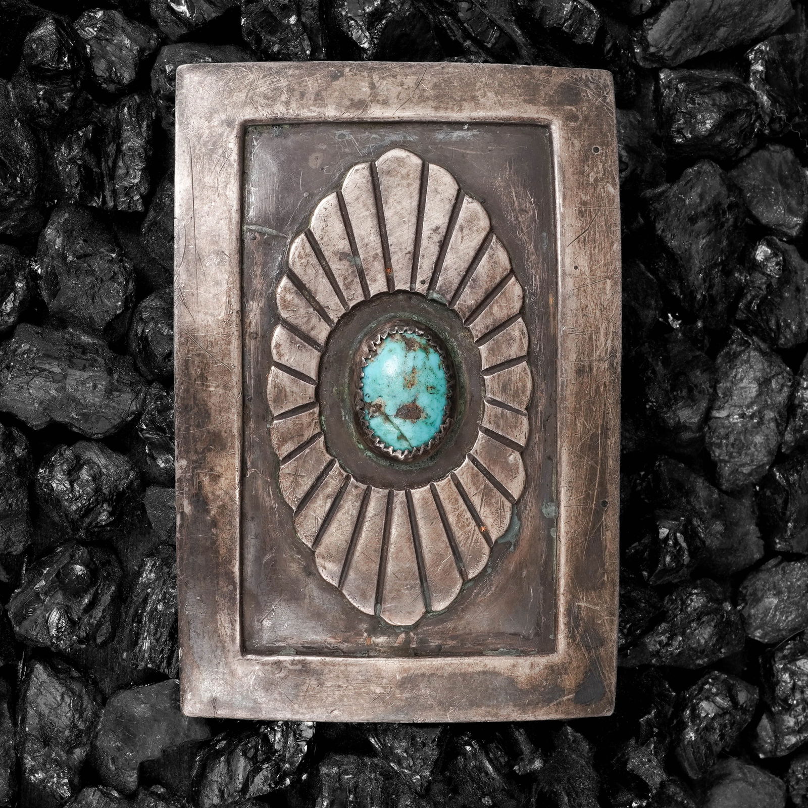 Vintage Navajo Sterling Silver & Turquoise Belt Buckle: Vintage Navajo Sterling Silver & Turquoise Belt BuckleCirca: 1970s-1980s, USAVintage Navajo Sterling silver belt buckle with a rectangular form and recessed border framing an incised radiating fan mot