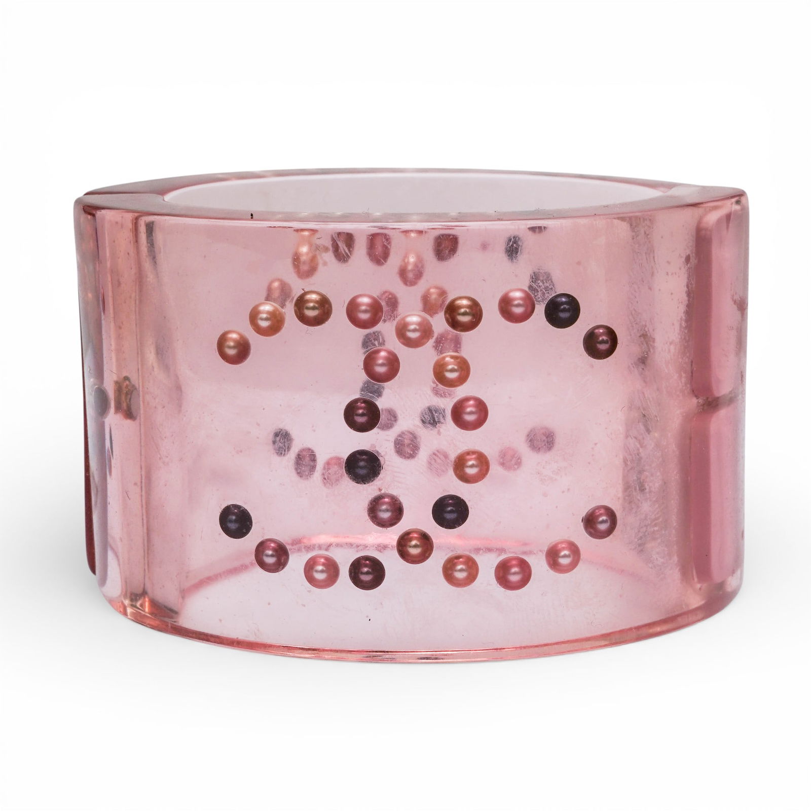 Chanel Pink Lucite Hinged Bangle Bracelet: Chanel Pink Lucite Hinged Bangle BraceletCirca 2008, FrenchWide Chanel hinged bangle executed in translucent rose-pink lucite, formed with a curved, high-gloss exterior and a molded interior row of ro