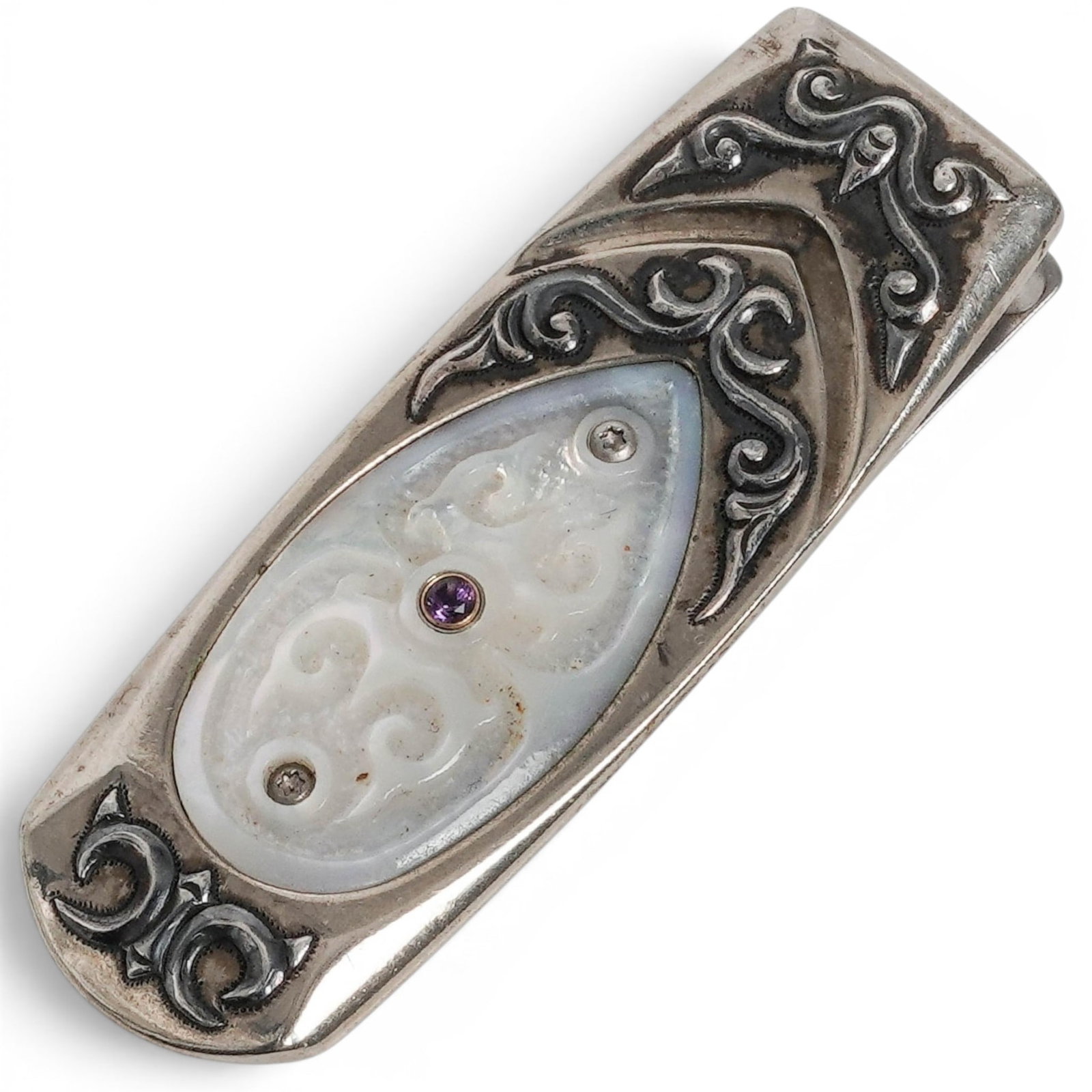 William Henry Orchid Limited Edition Money Clip: William Henry Orchid Limited Edition Money Clip 21st Cent, USA William Henry Orchid limited edition money clip crafted in stainless steel, featuring a wavy engraved motif with an oval mother-of-pearl 