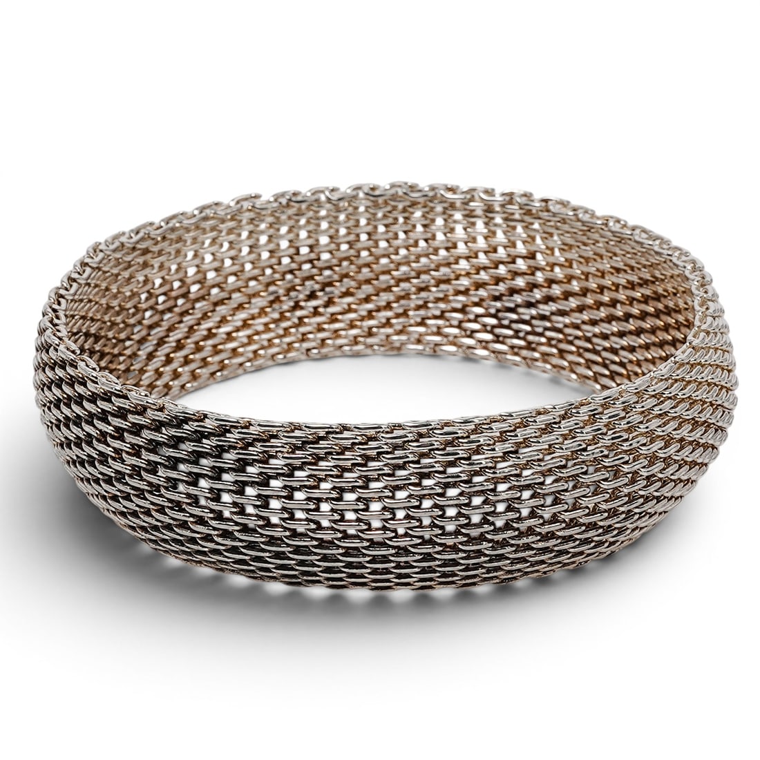 Vintage Sterling Silver Mesh Weave Bracelet: Vintage Sterling Silver Mesh Weave Bracelet 1980s–1990s Flexible sterling silver bracelet executed in a dense mesh weave with rounded edge links and a concealed box clasp. Attached hallmark tag stam