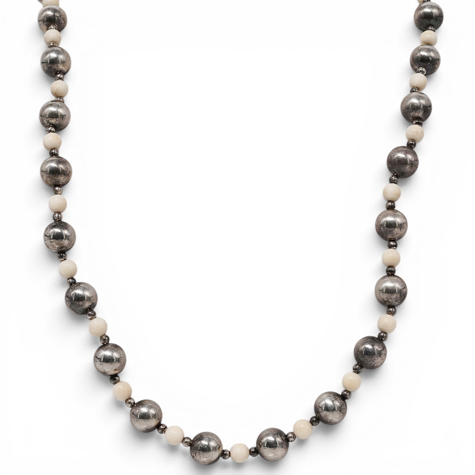 Vintage Sterling Silver & Carved Bone Bead Necklace: Vintage Sterling Silver & Carved Bone Bead Necklace 1970s–1980s Vintage necklace composed of polished sterling silver hollow beads alternating with hand-carved bone beads, strung on wire and finishe