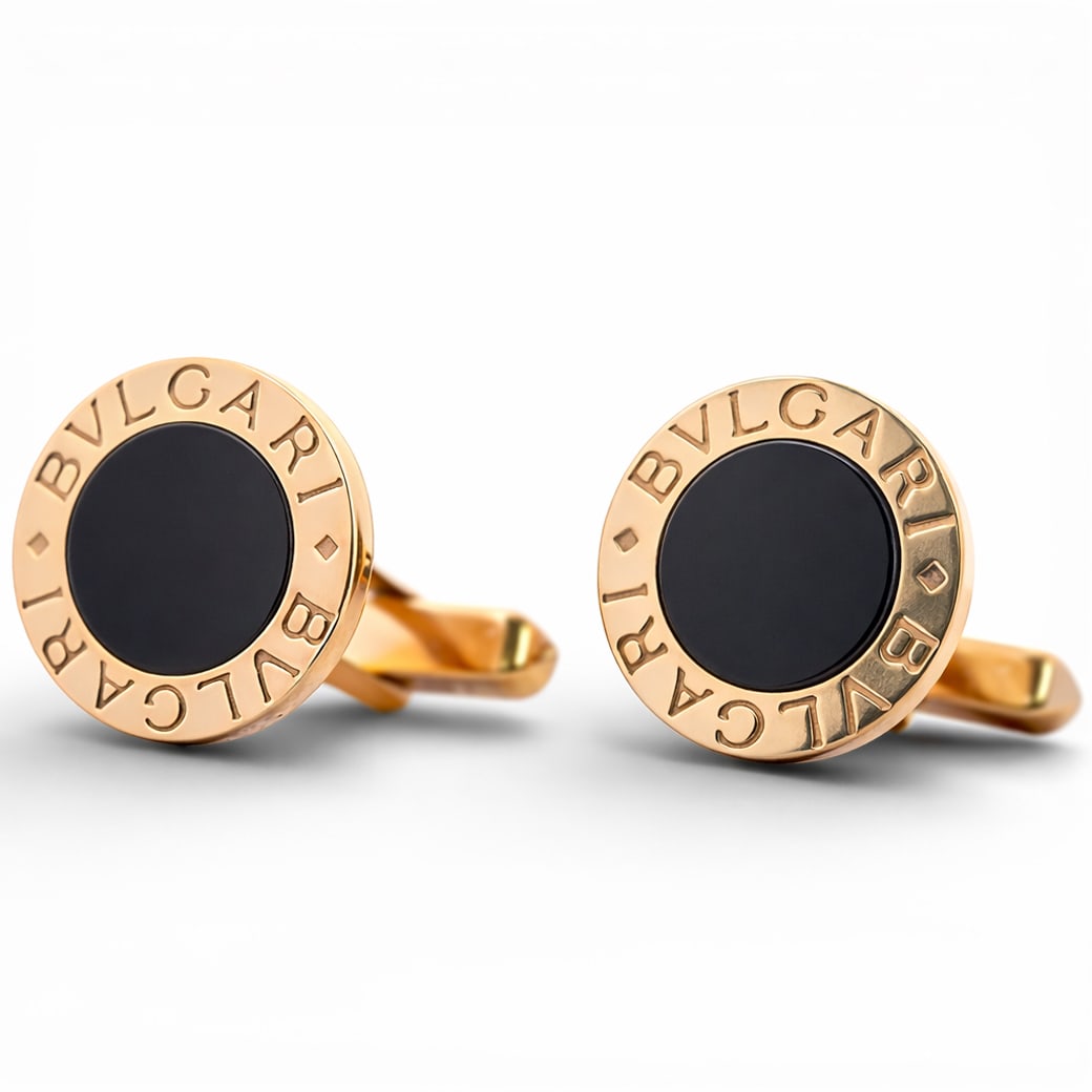 Bulgari 18k Gold & Black Onyx Cufflinks: Bulgari 18k Gold & Black Onyx CufflinksCirca 1990s-2000s, Italian18k yellow gold pair of cufflinks by Bulgari, each designed as a circular plaque engraved BVLGARI BVLGARI around a centrally set polish